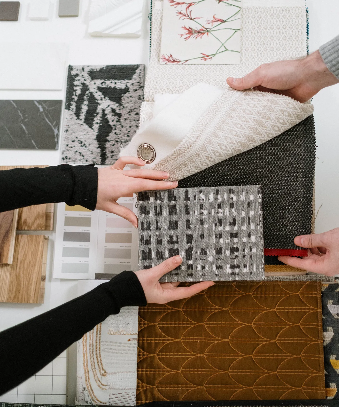 Upholstery fabric swatches being compared as an illustrative material-selection reference