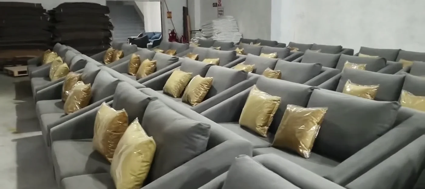 Gray upholstered chairs and protected cushions arranged in the workshop