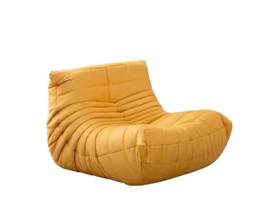 Low mustard lounge chair with deep seat and continuous channel tufting