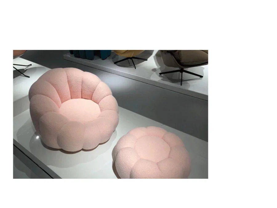 Pink flower-form upholstered lounge chair with matching segmented ottoman