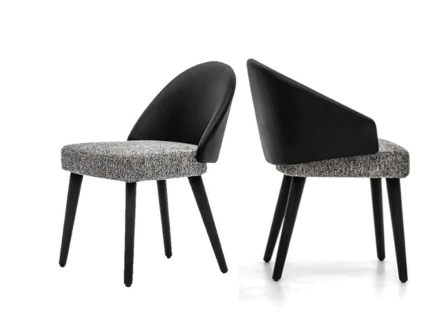 Curved upholstered dining chair shown in arm and armless versions with tapered wood legs