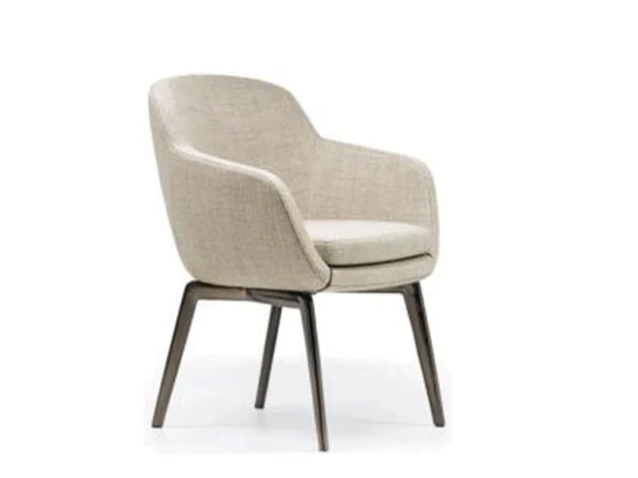Winged cream upholstered dining armchair on slim metal legs