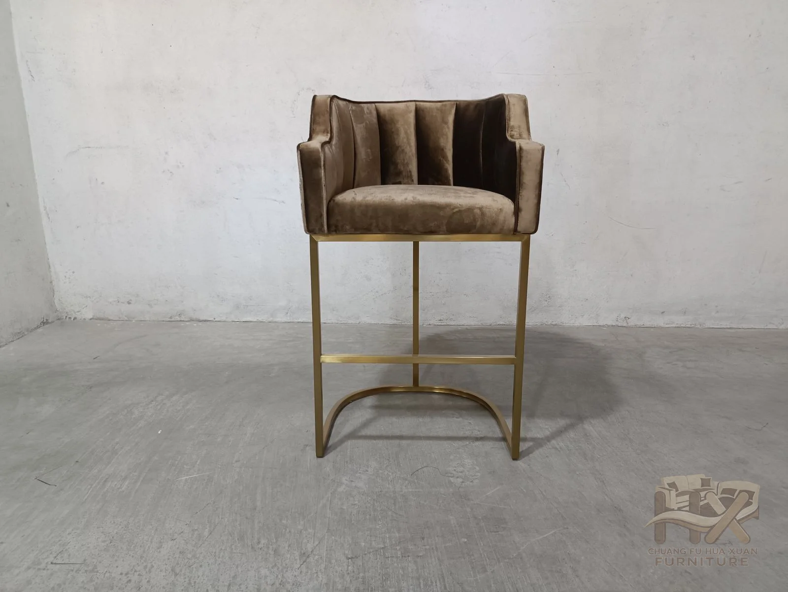 A compact upholstered tub seat sits above an airy metal-look pedestal, with a low horizontal foot support and patterned outer shell.