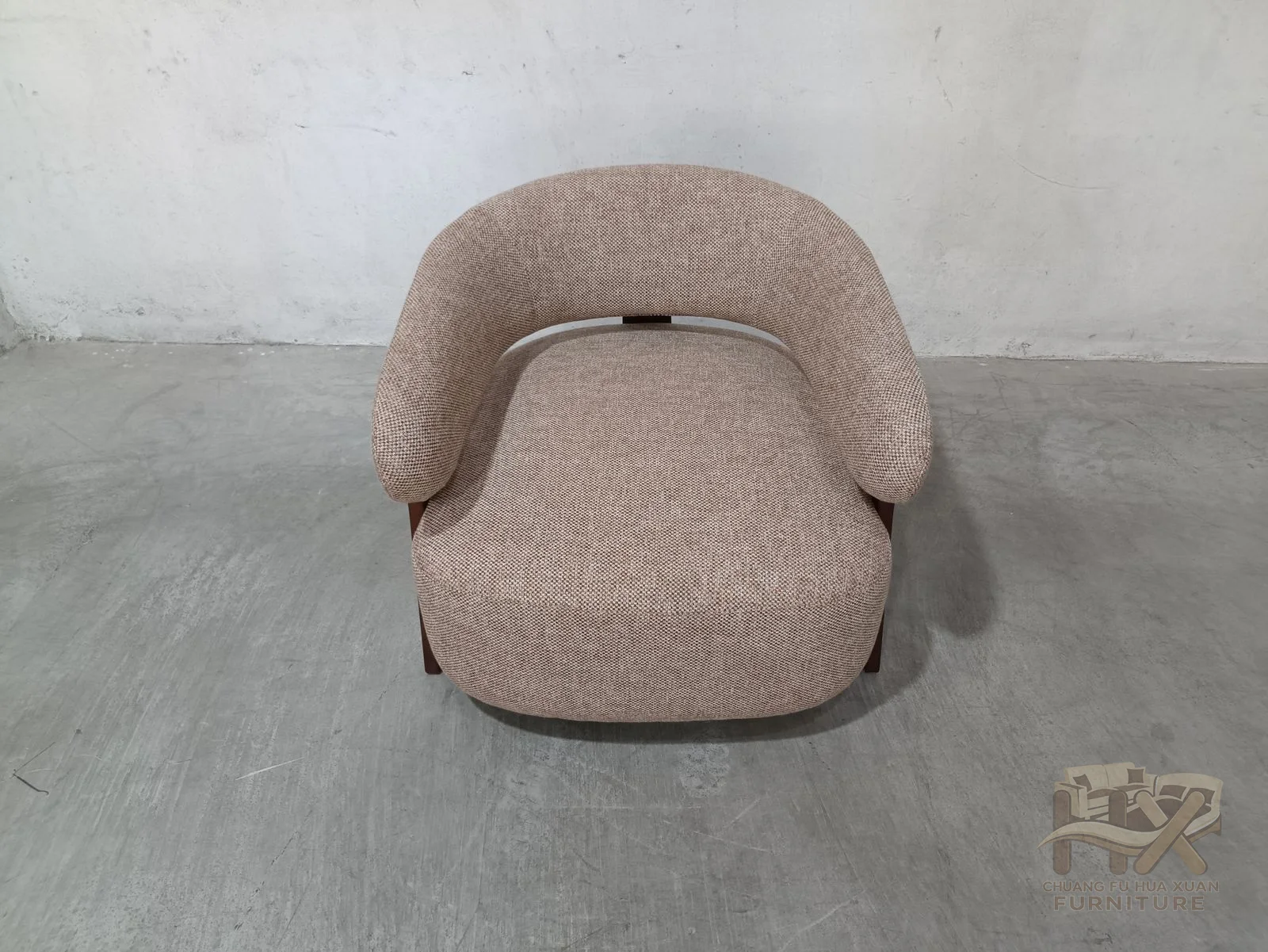 A low rounded seat is framed by upholstered arms and exposed dark wood-look supports that continue down the outer sides.