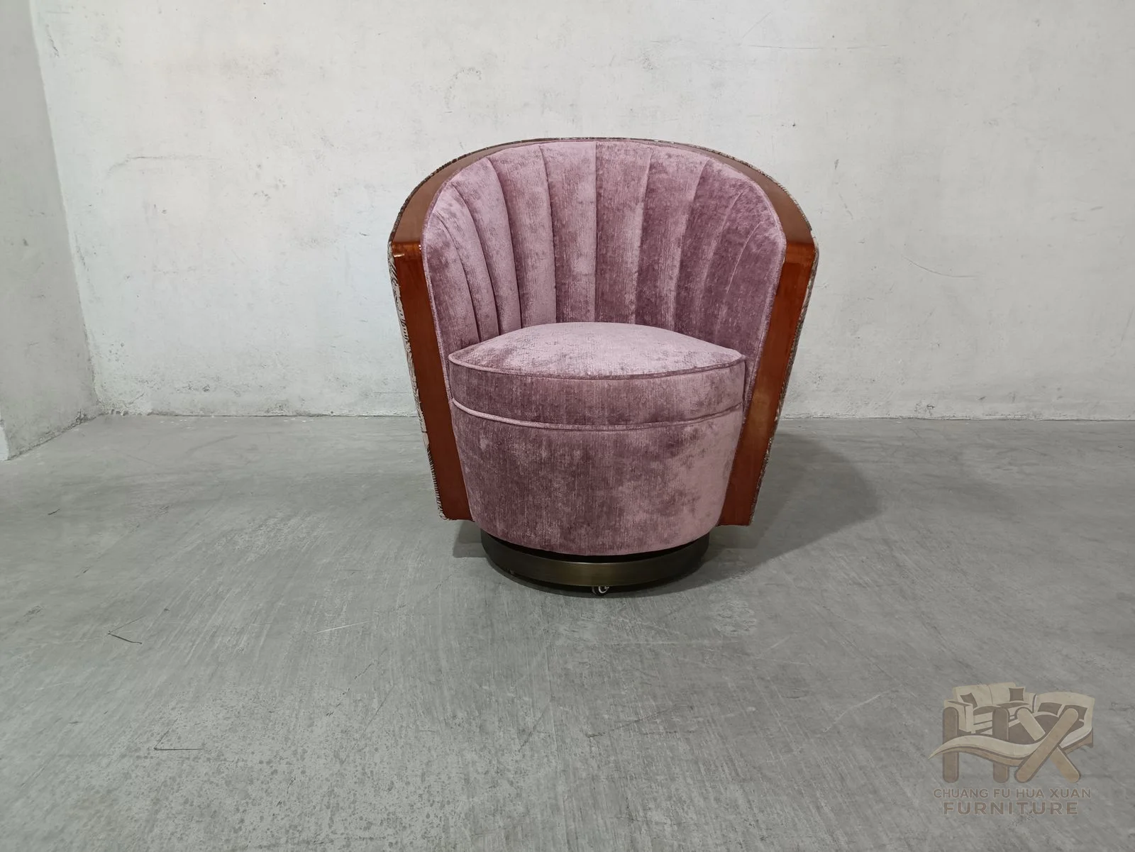 Narrow vertical channels fan across the curved inner back, and a contrasting patterned shell wraps the outside of the pink seat.