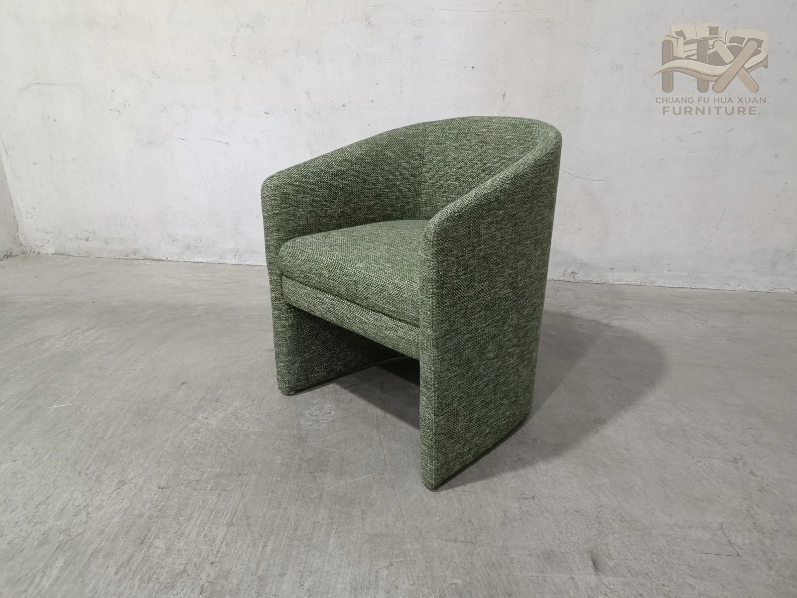A close-fitting curved back and arms sit above an open lower cutout that separates the upholstered shell from the floor.