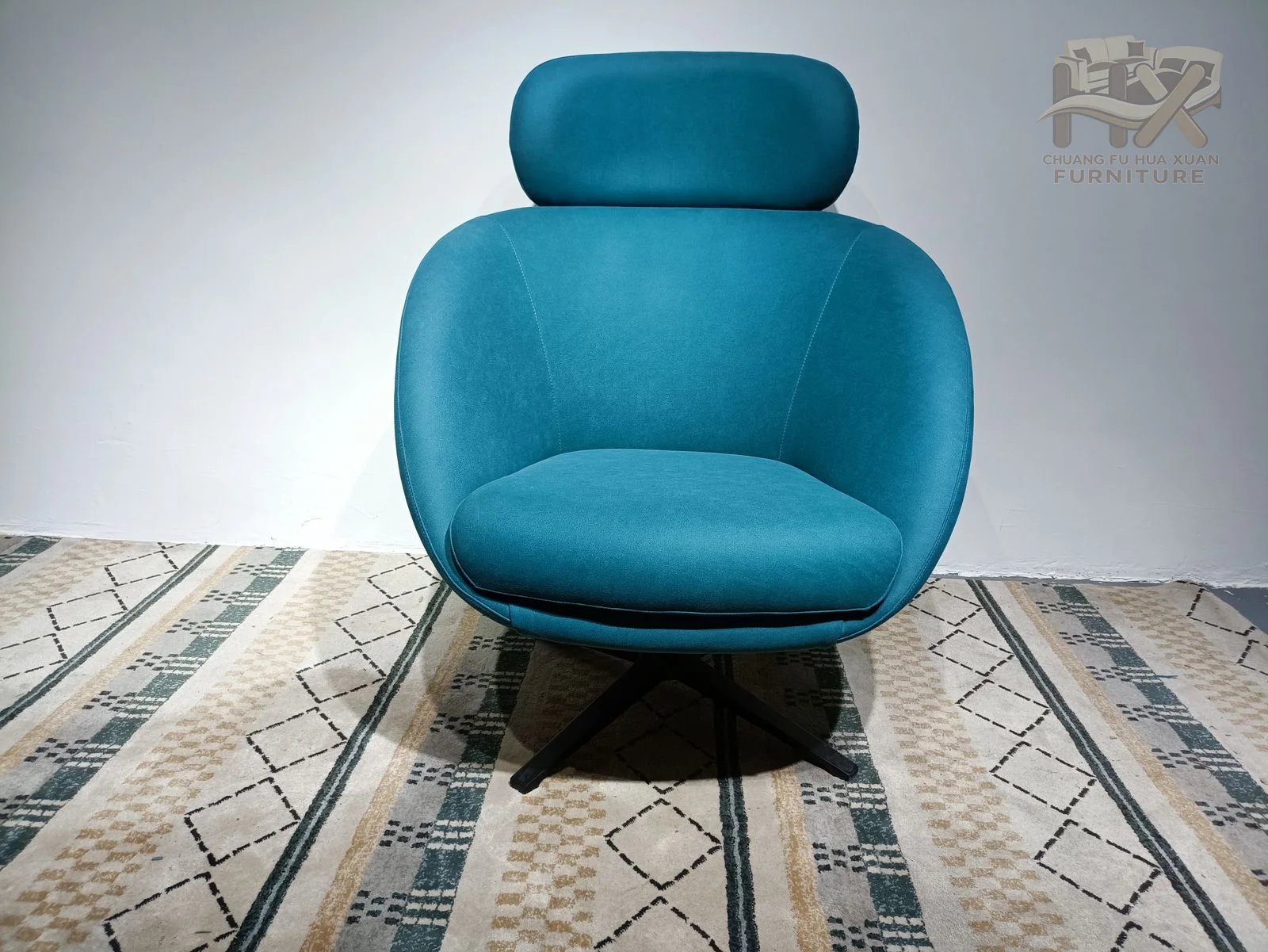 A deep blue rounded seat carries a small separate headrest and sits on a black cross base.