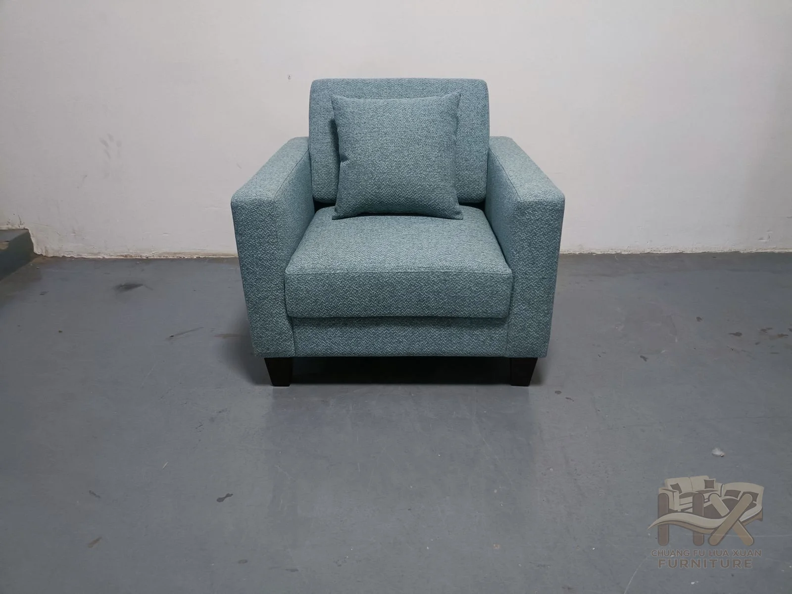 Square arms and a deep pale blue seat cushion give this lounge chair a firm-edged, comfortable appearance.