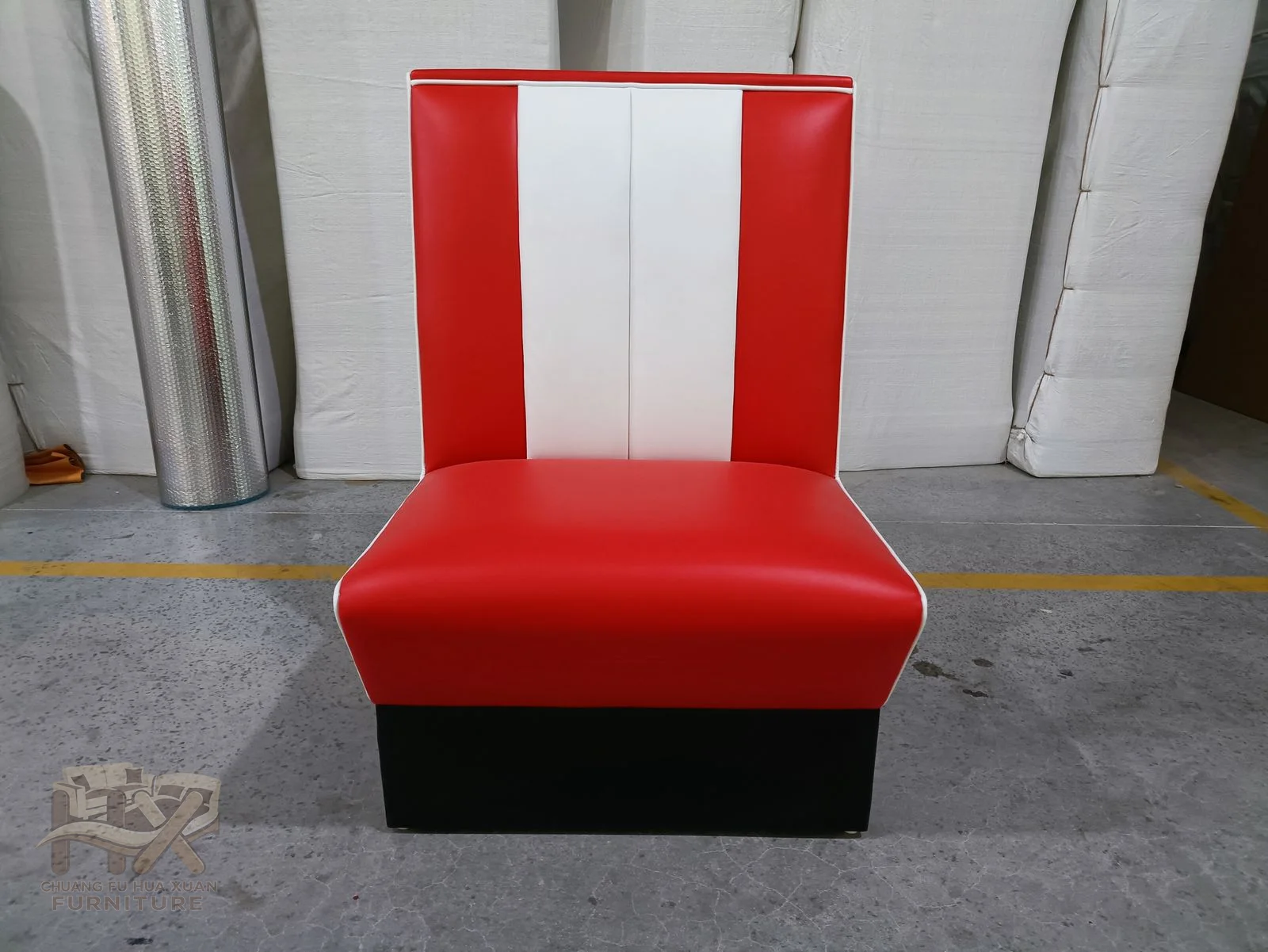 Bold red upholstery frames a tall white centre panel and extends across the seat of this upright banquette.