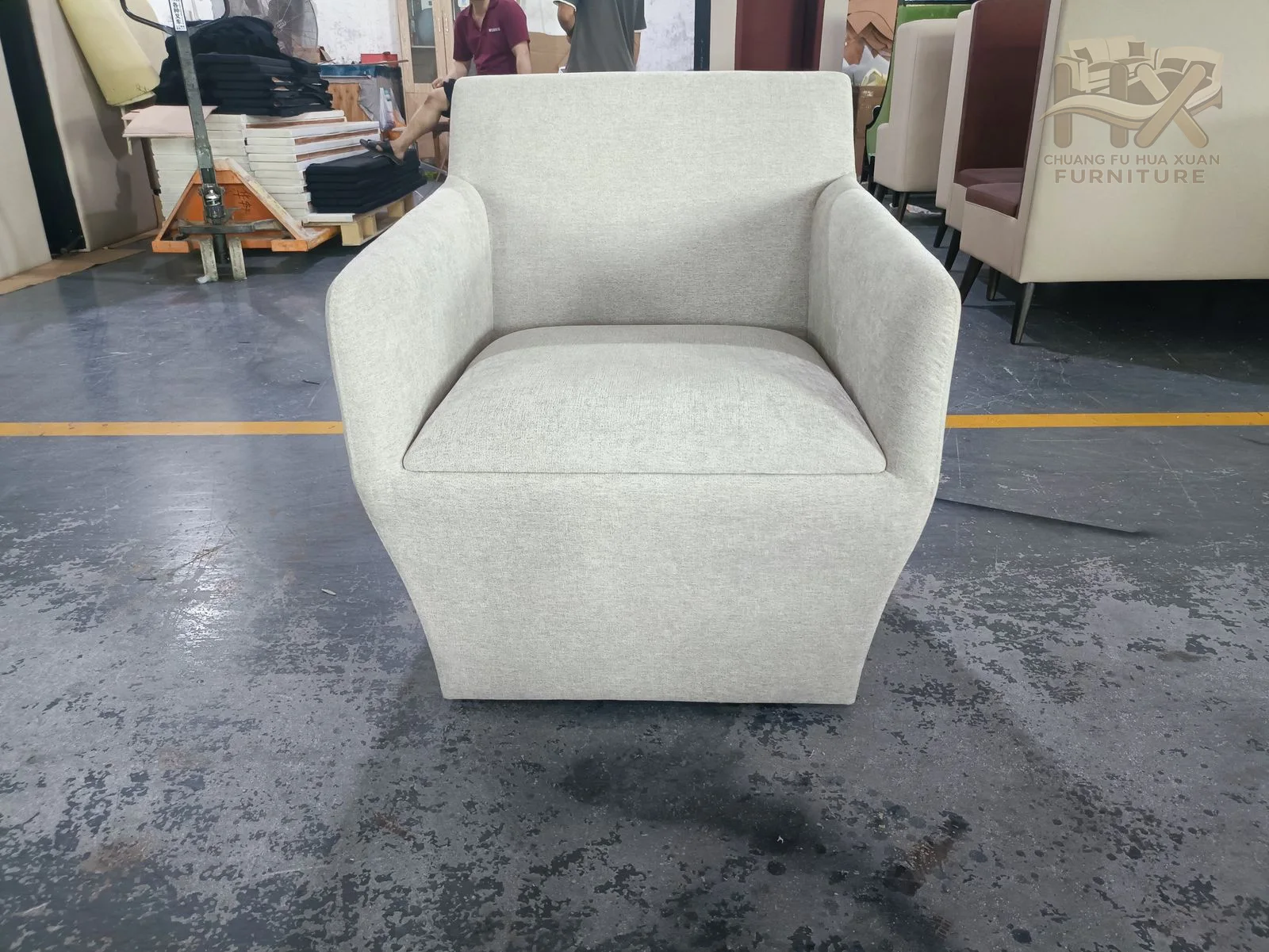 A white padded back curves into short arms around a compact seat on low feet.