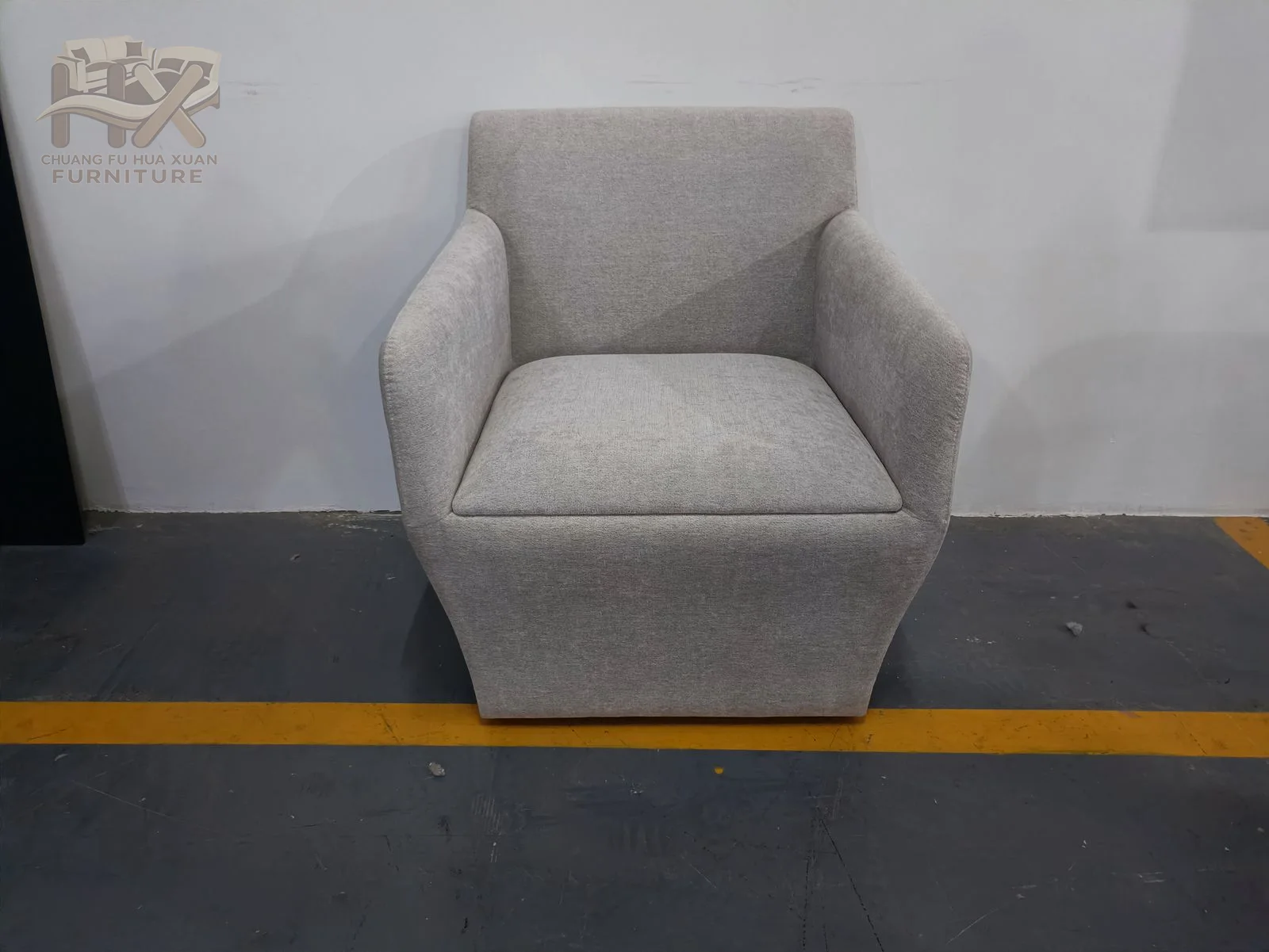 Broad box arms meet a high padded back above a white seat cushion, creating a compact but substantial silhouette.
