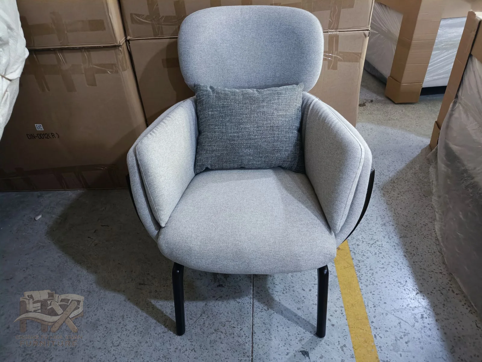 A grey outer shell wraps a pale inner cushion, with gently winged shoulders and slim dark legs.