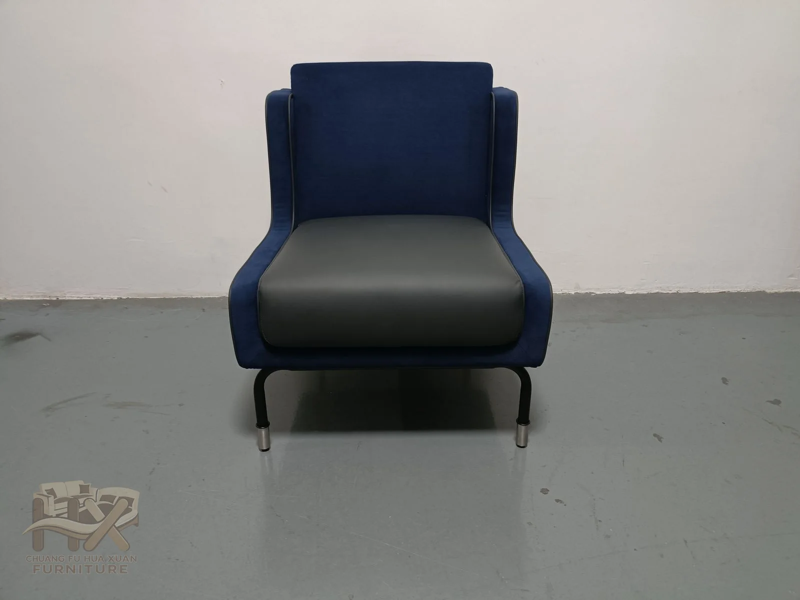 A dark seat and base contrast with a deep blue straight back, with no projecting arms.