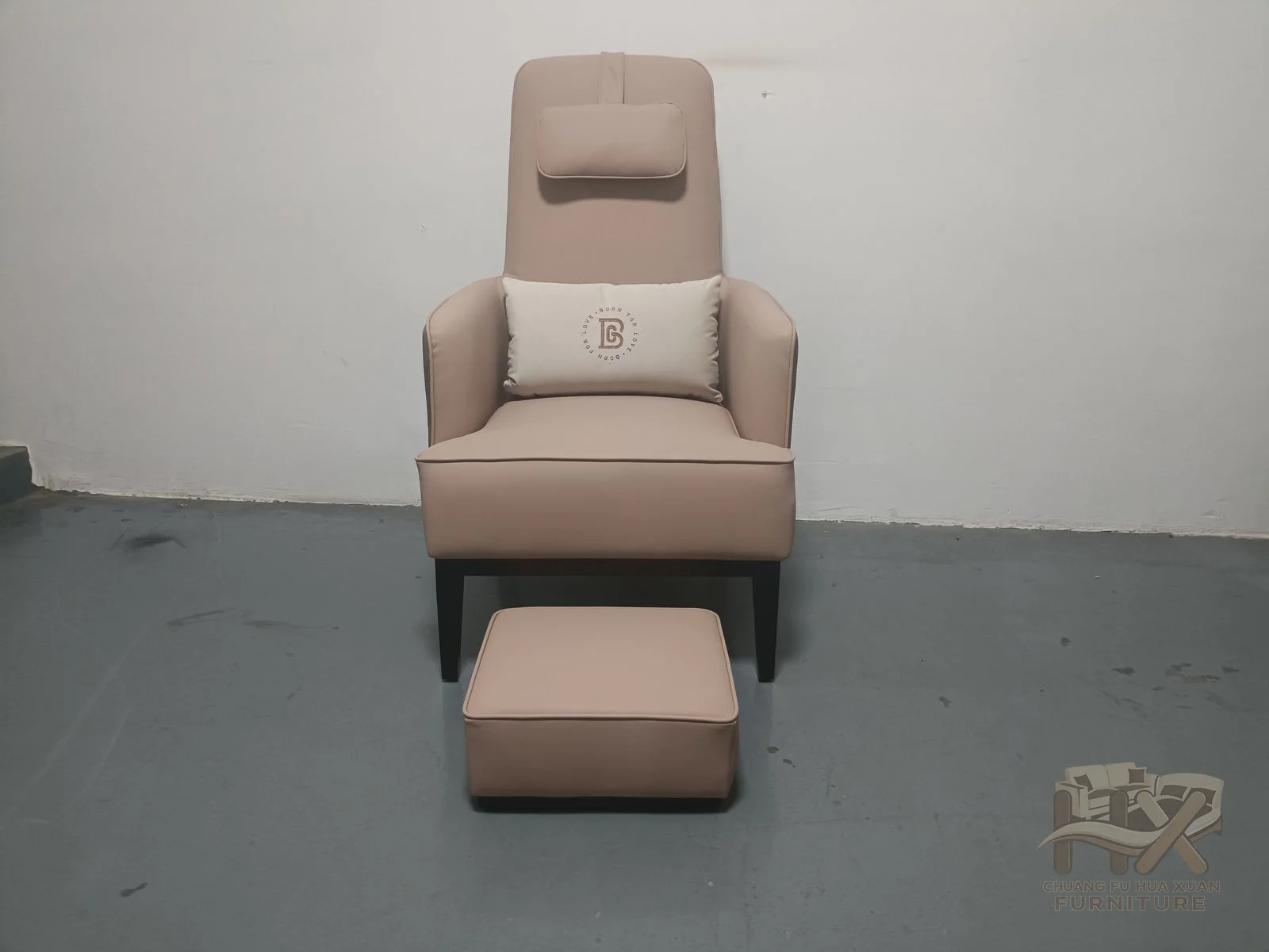 A tall pale chair is paired with a matching small footstool, both with compact upholstered bases.
