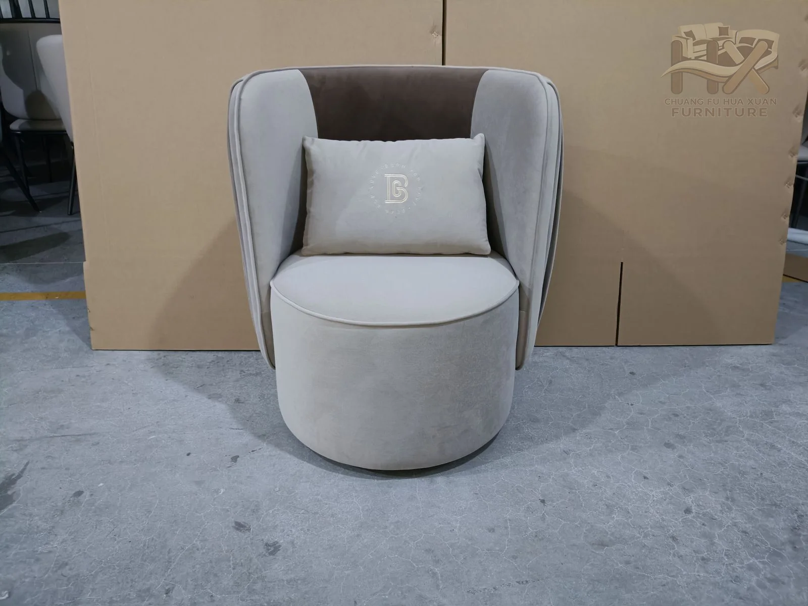 A white tub chair hides its base below a curved back marked by vertical exterior ribs.