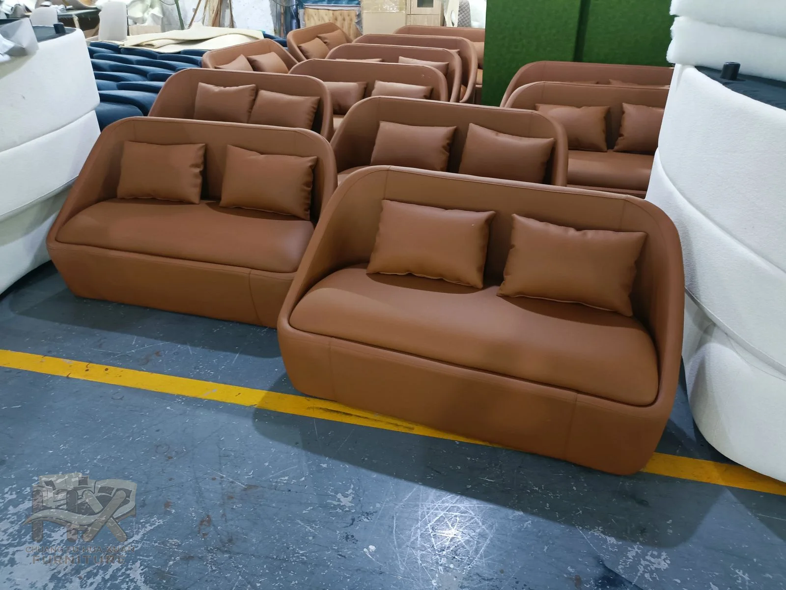 A brown padded lounge chair carries a tall back and an extended reclining foot section.