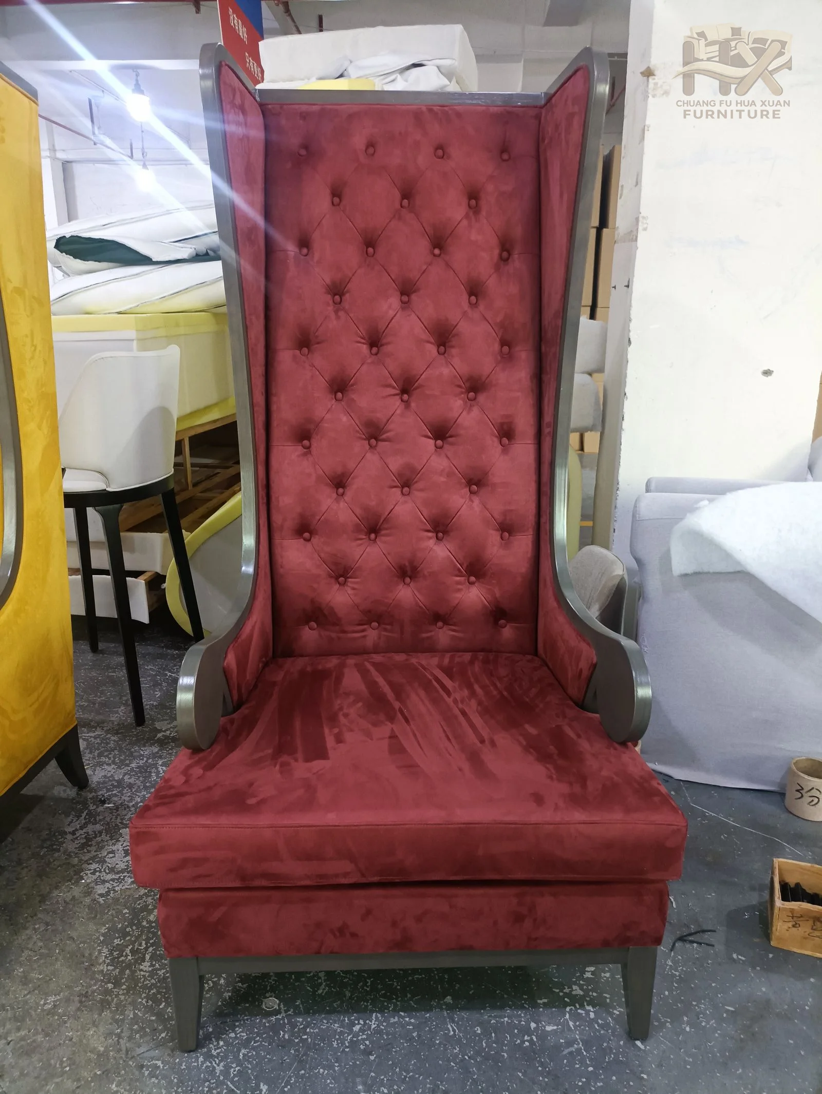 A very tall tufted chair is shown in red and yellow upholstery over a deep single seat.