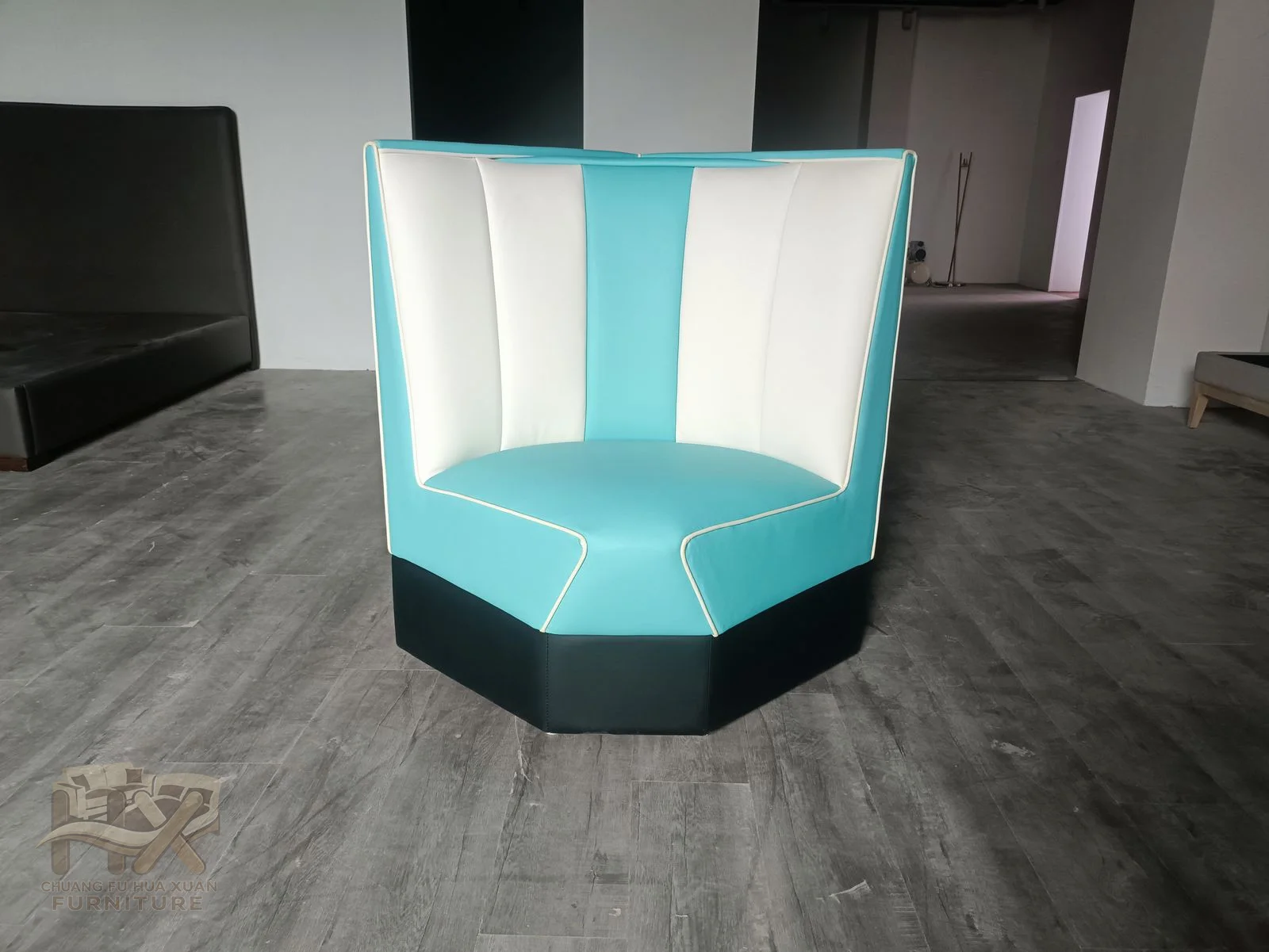 A compact booth seat alternates turquoise and white panels across a tall padded back.