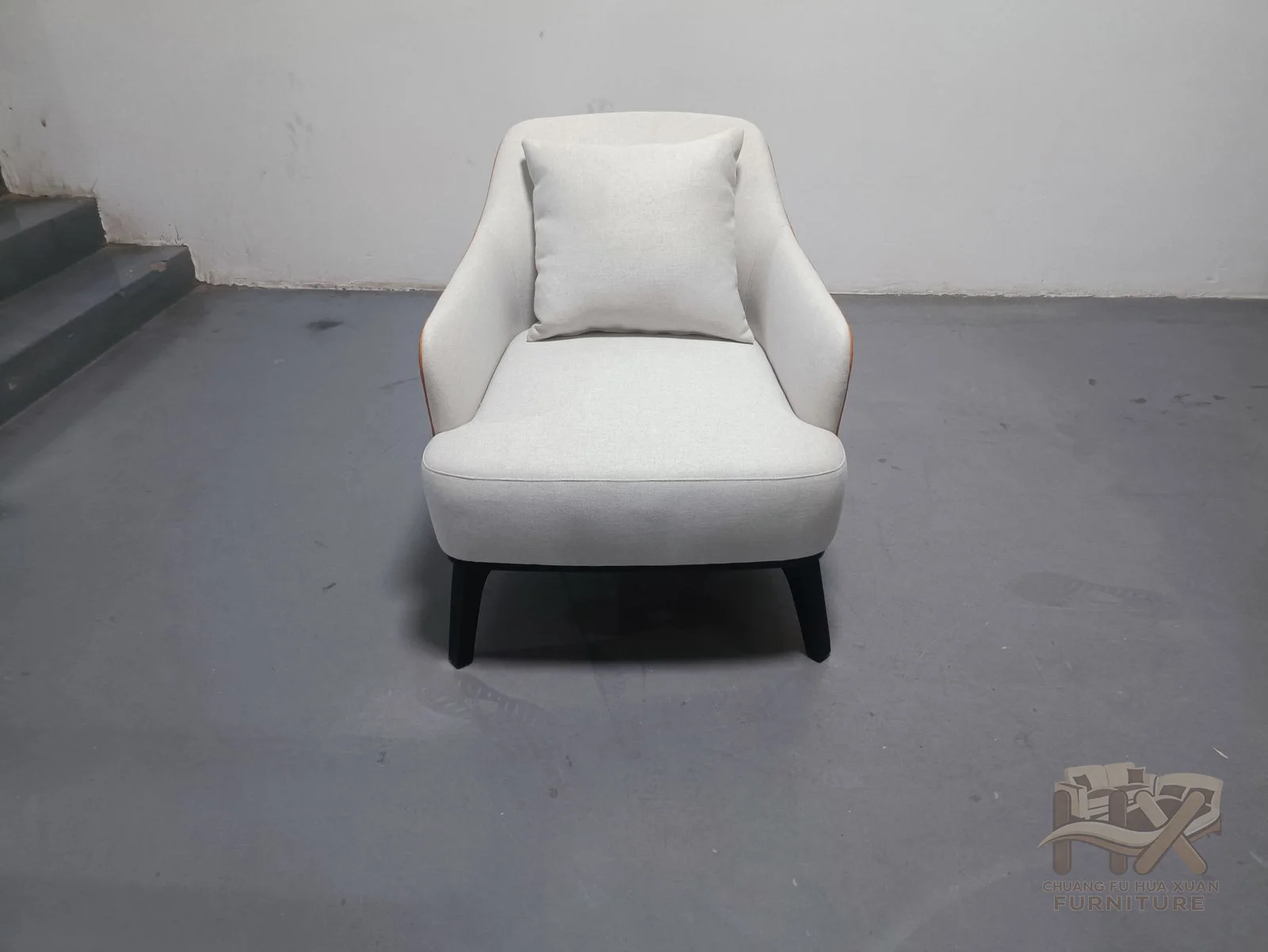 A pale seat and back are wrapped by a warm ochre outer shell on a low base.
