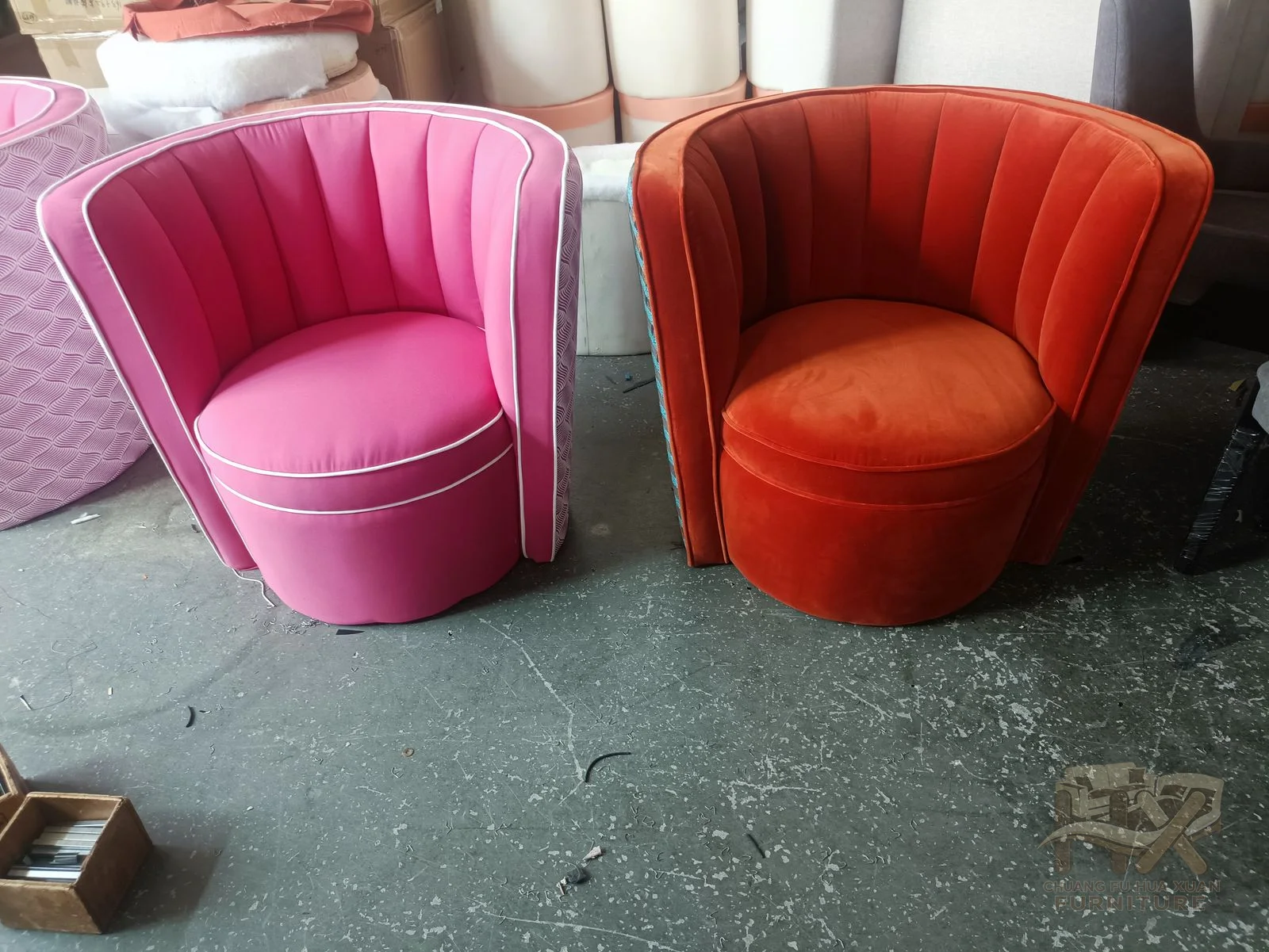 A small tub chair has a fluted outer back and rounded seat, shown in pink and rust.