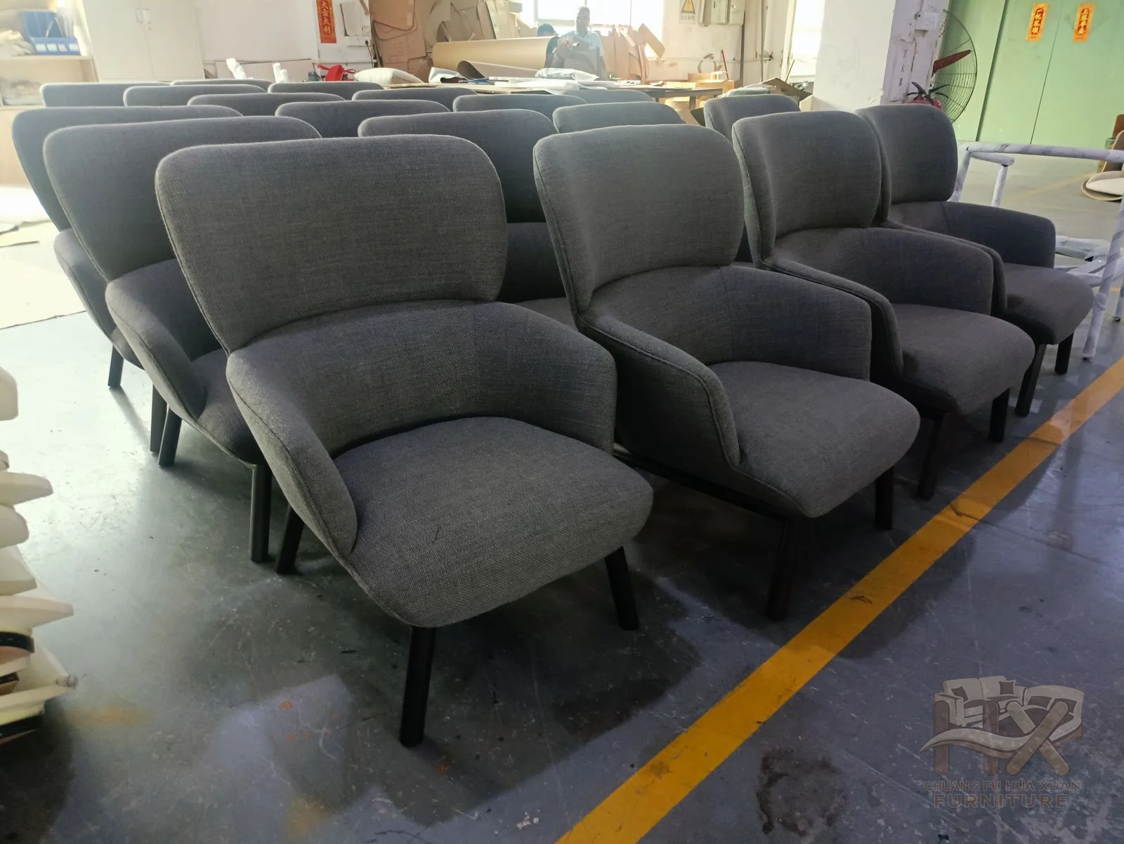 A grey reclining chair has a tall segmented back, broad arms and an extending footrest.