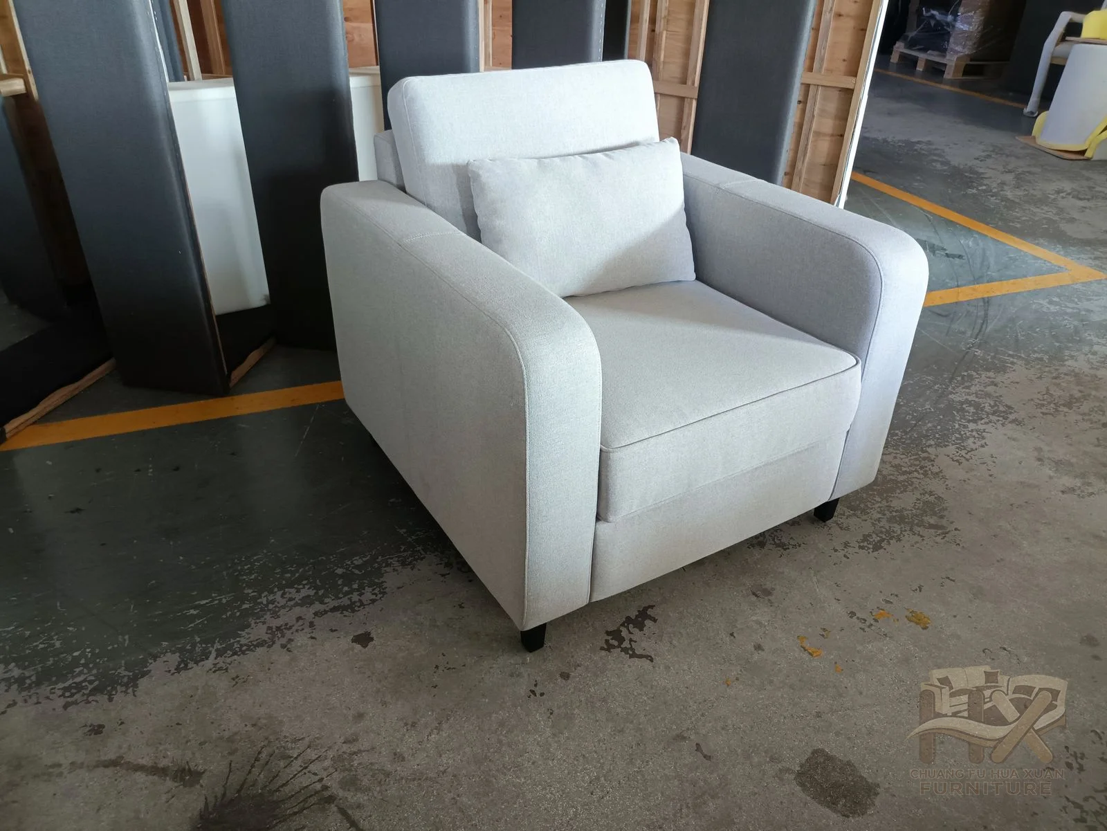 A white individual chair places a deep seat between substantial square upholstered arms.