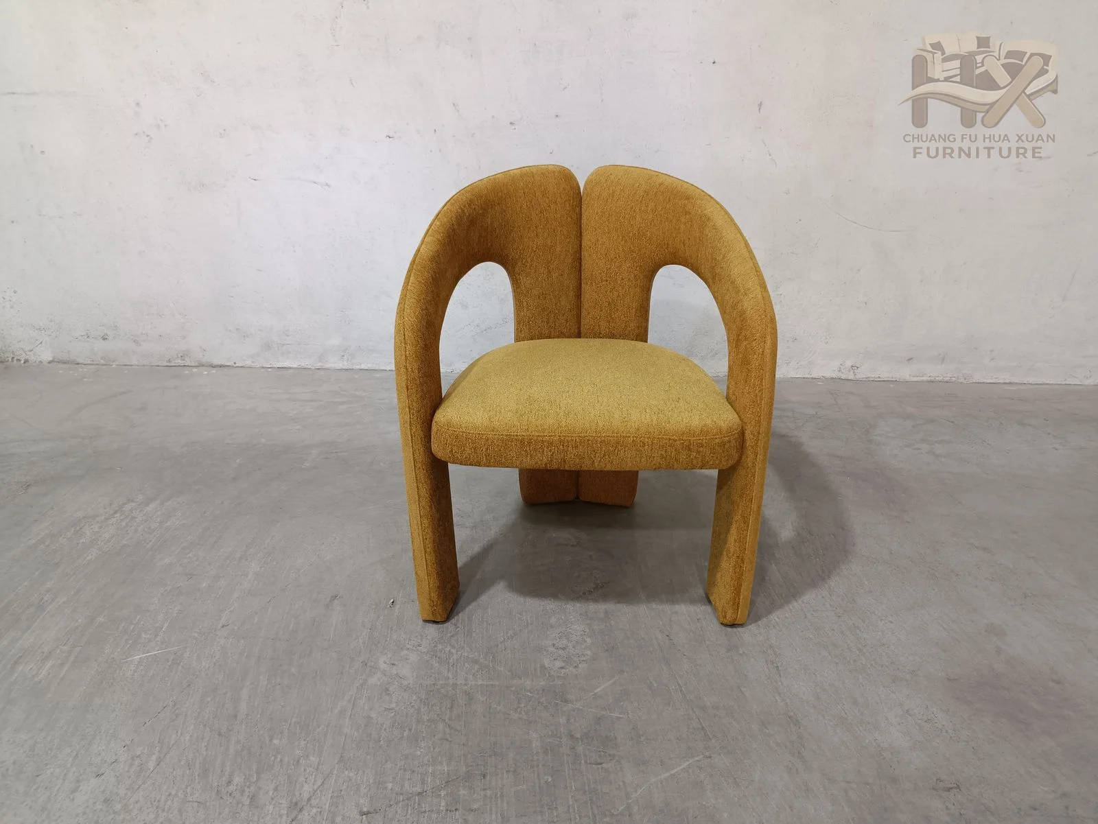 The upholstered frame forms two open arches beneath the arms, with a compact seat held inside the rounded back and leg profile.