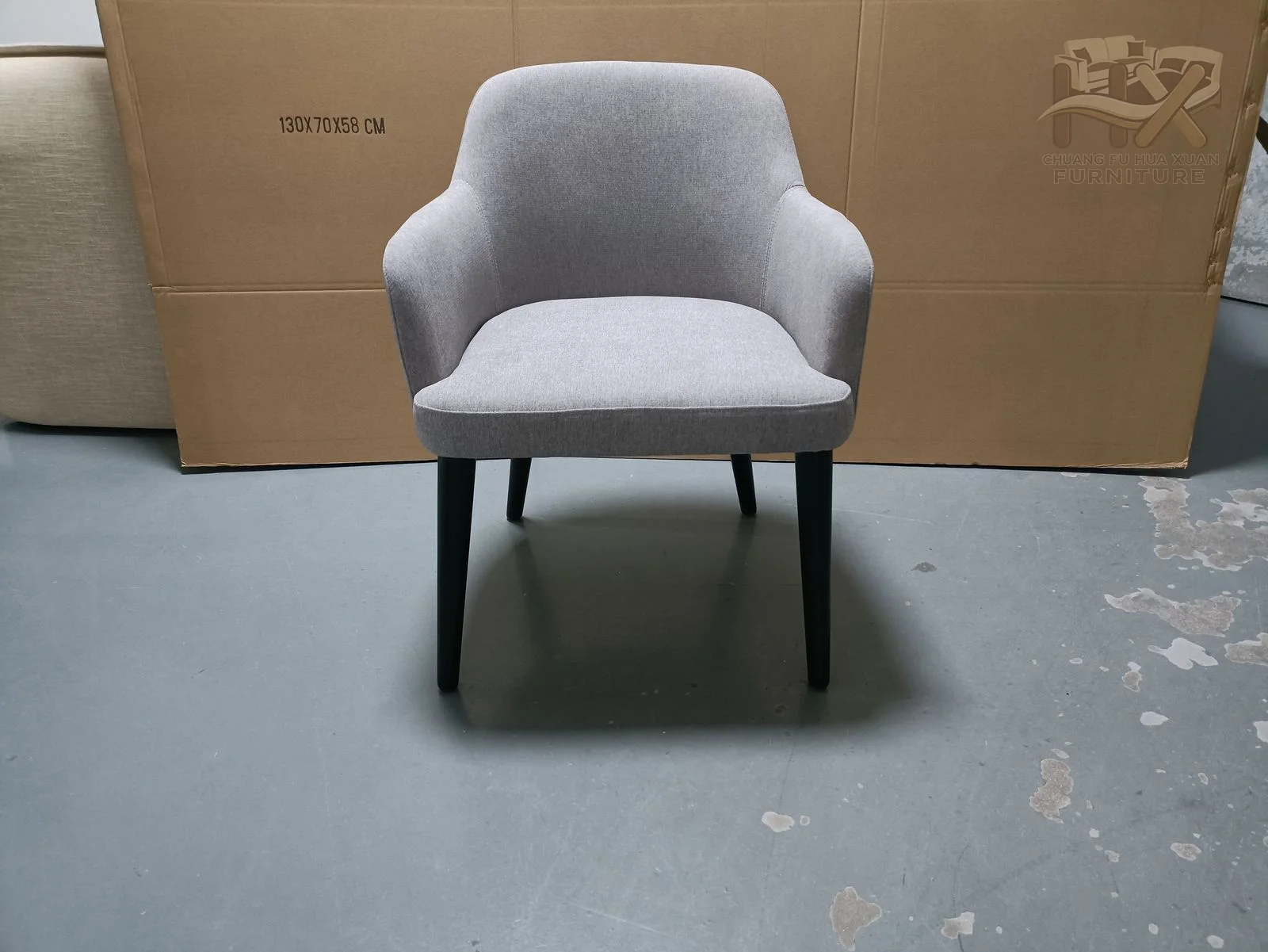 Grey and blue versions share a softly curved back, short integrated arms and slim dark legs.
