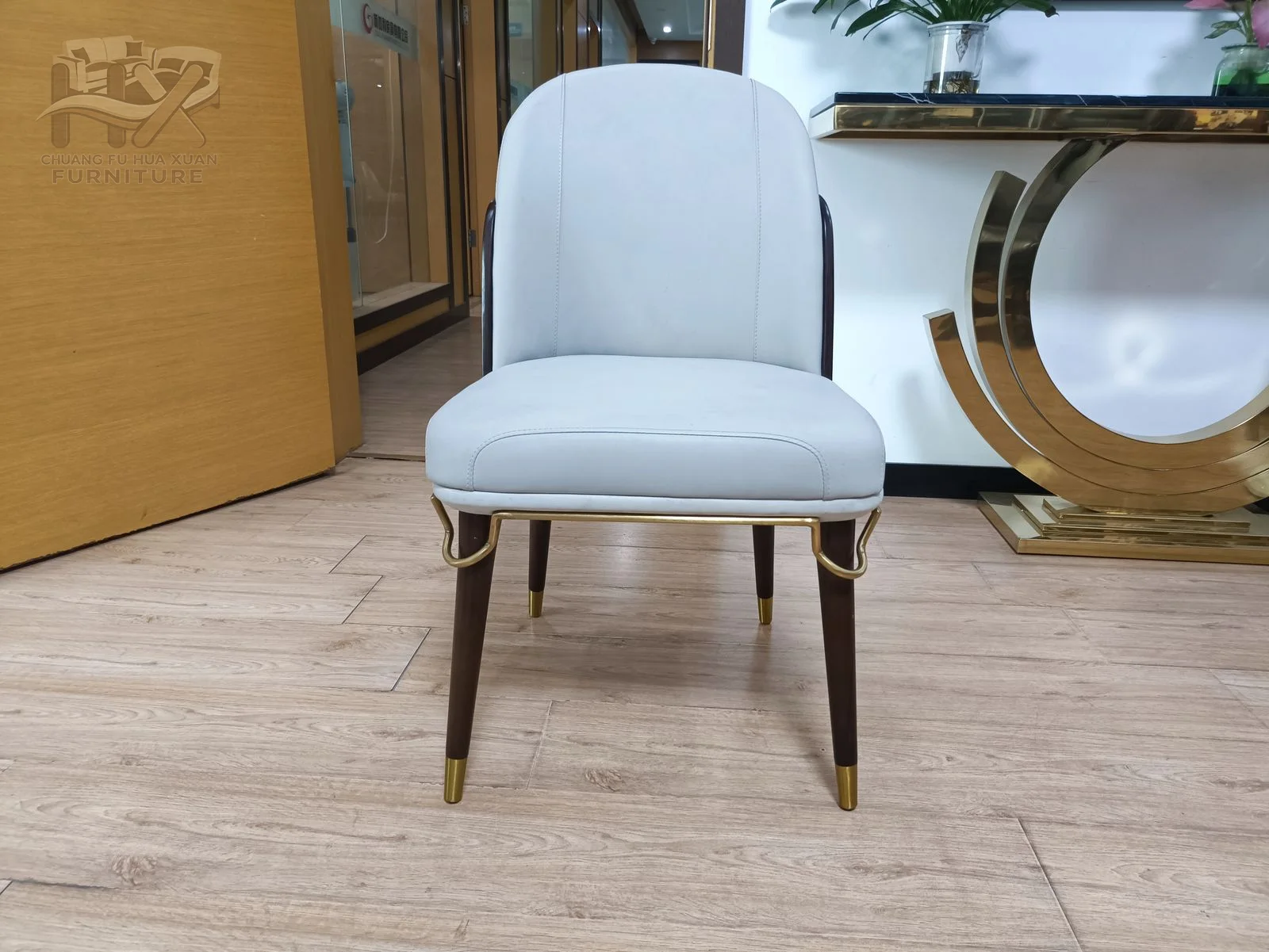A pale seat and back face contrast with a much darker outer shell above tapered legs.