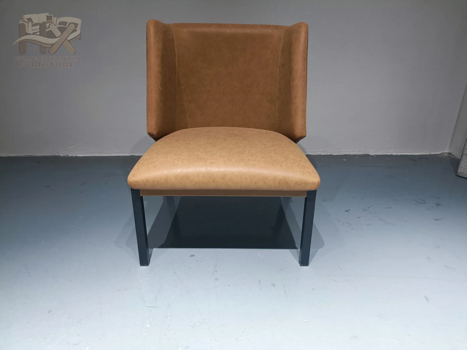 The tan dining chair rises into a tall slightly tapered back above a simple padded seat and dark legs.