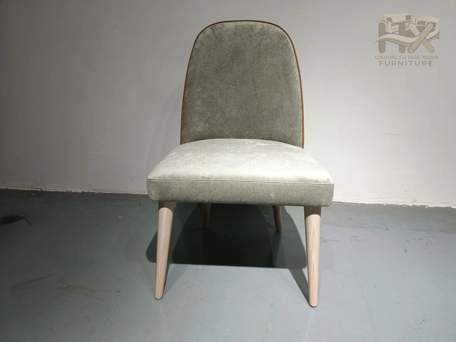 A pale seat and inner back contrast with a warm brown outer back above dark tapered legs.