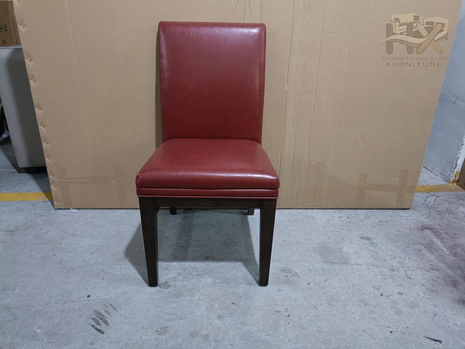 A tall narrow burgundy back rises from a simple padded seat above dark tapered legs.