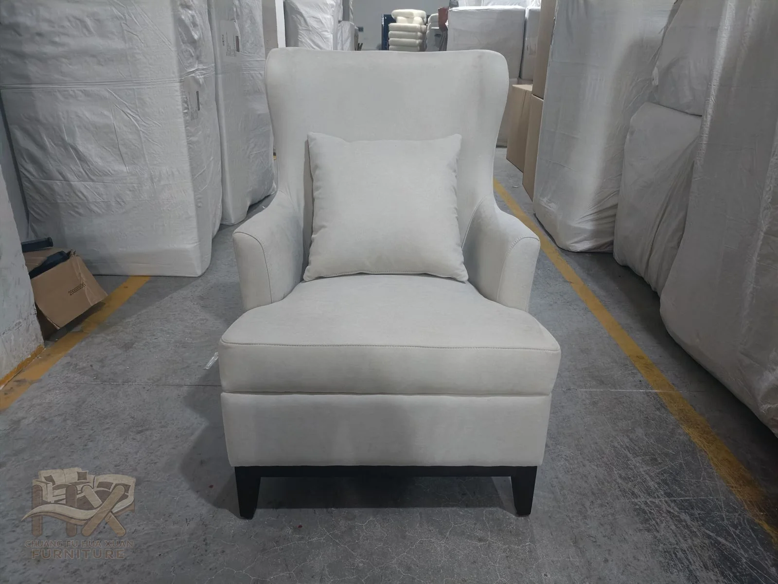 A pale upholstered dining seat has a light open back and slim legs.