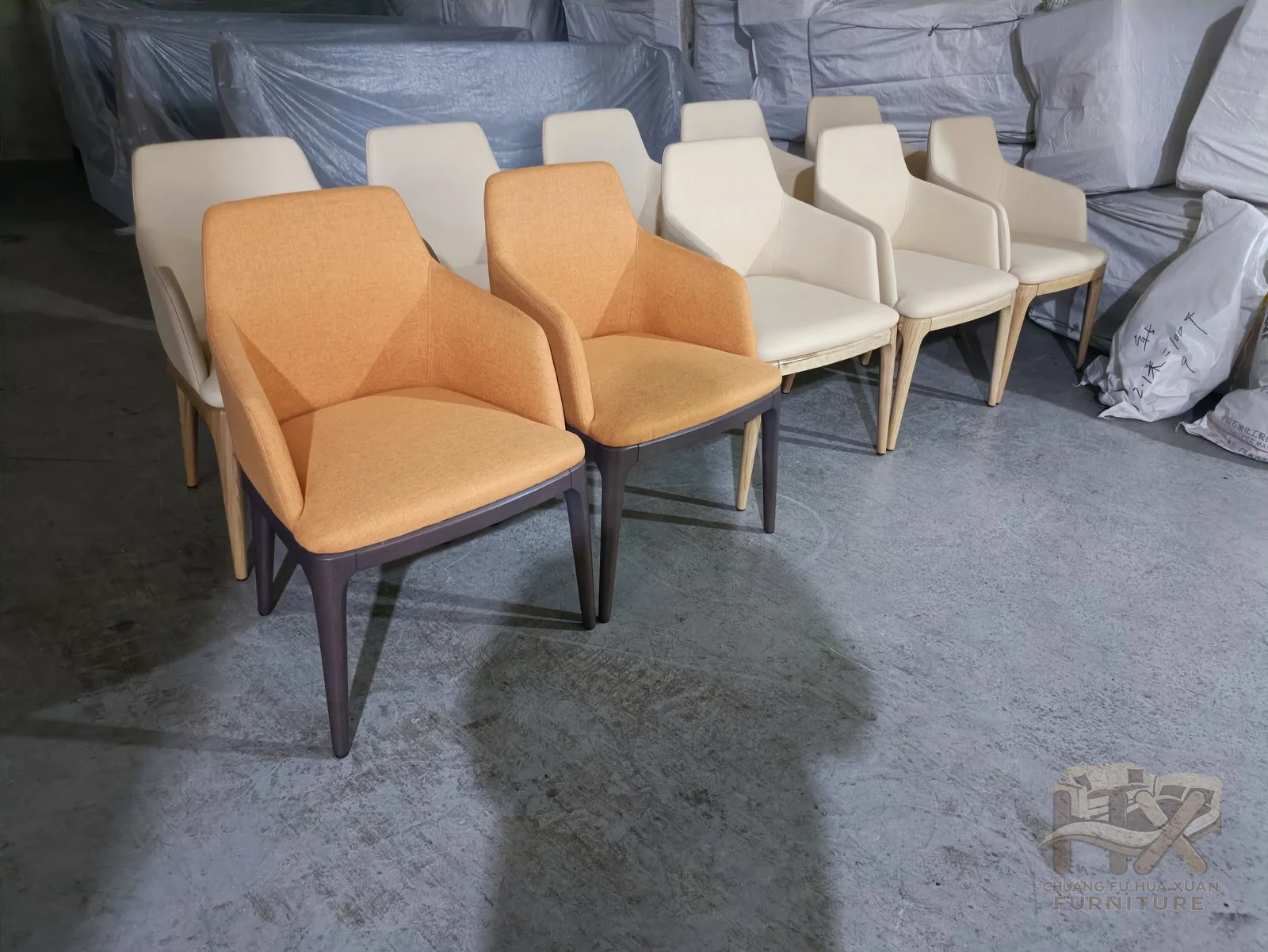 A compact upholstered seat and curved back stand on four visible wood-look legs.