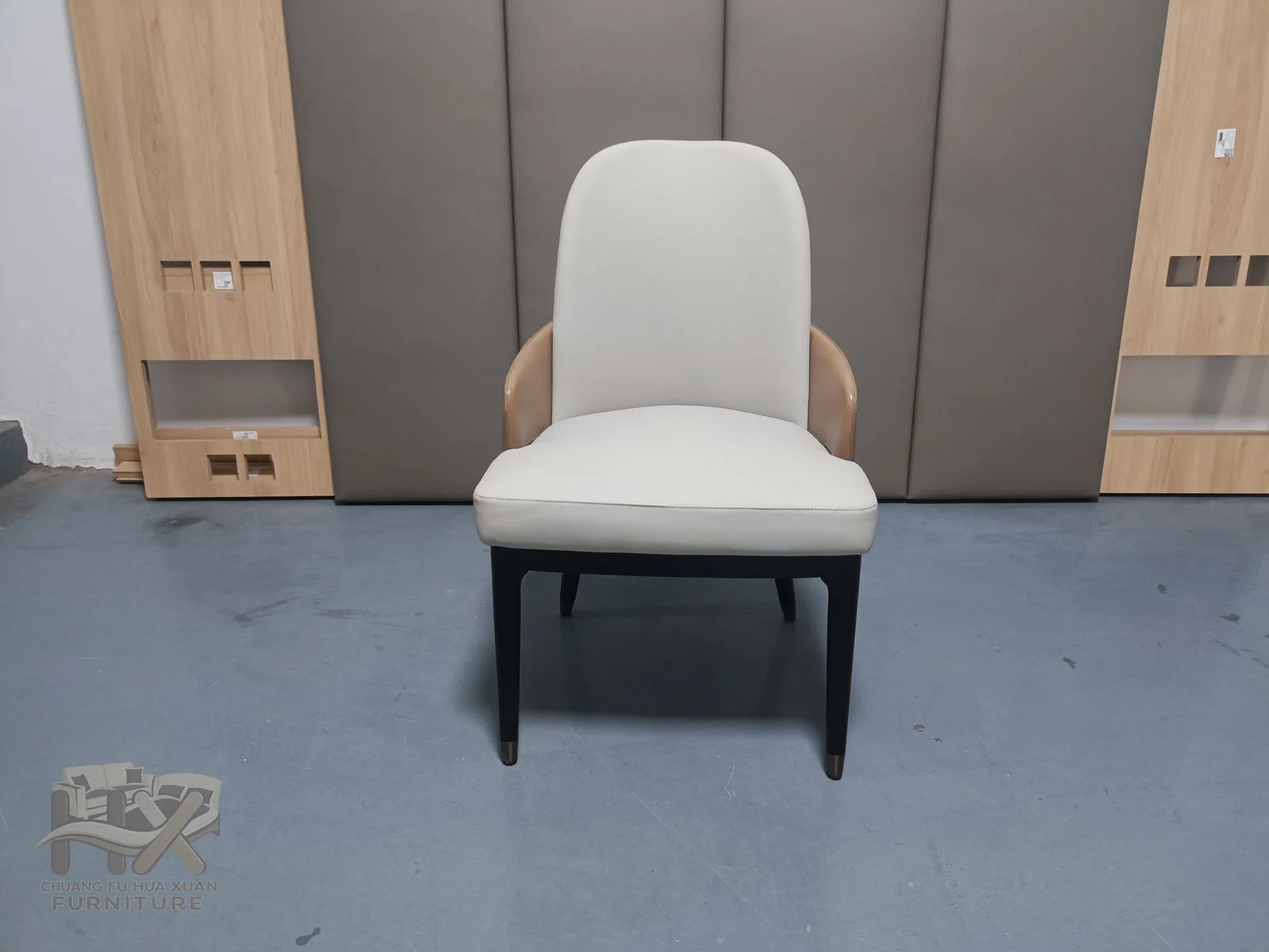 A light padded dining chair opens slightly at the upper back above slim legs.