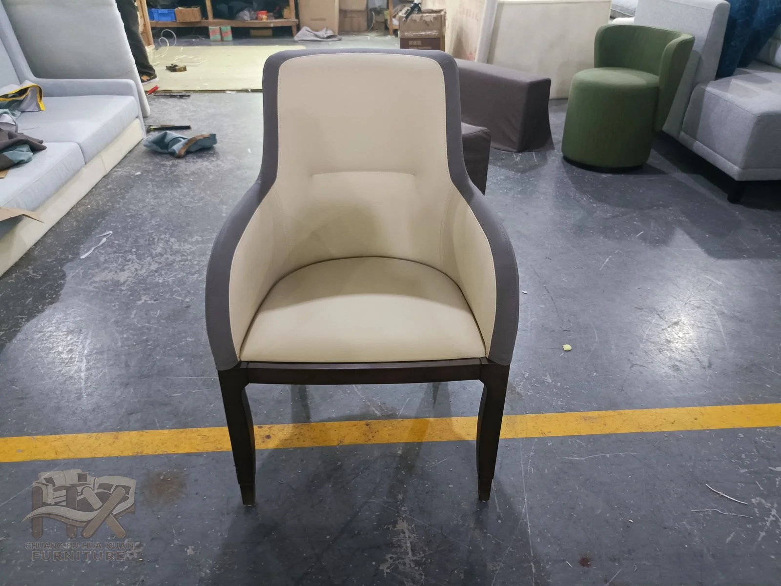 A cream dining chair uses a gently curved upholstered back above slim straight legs.