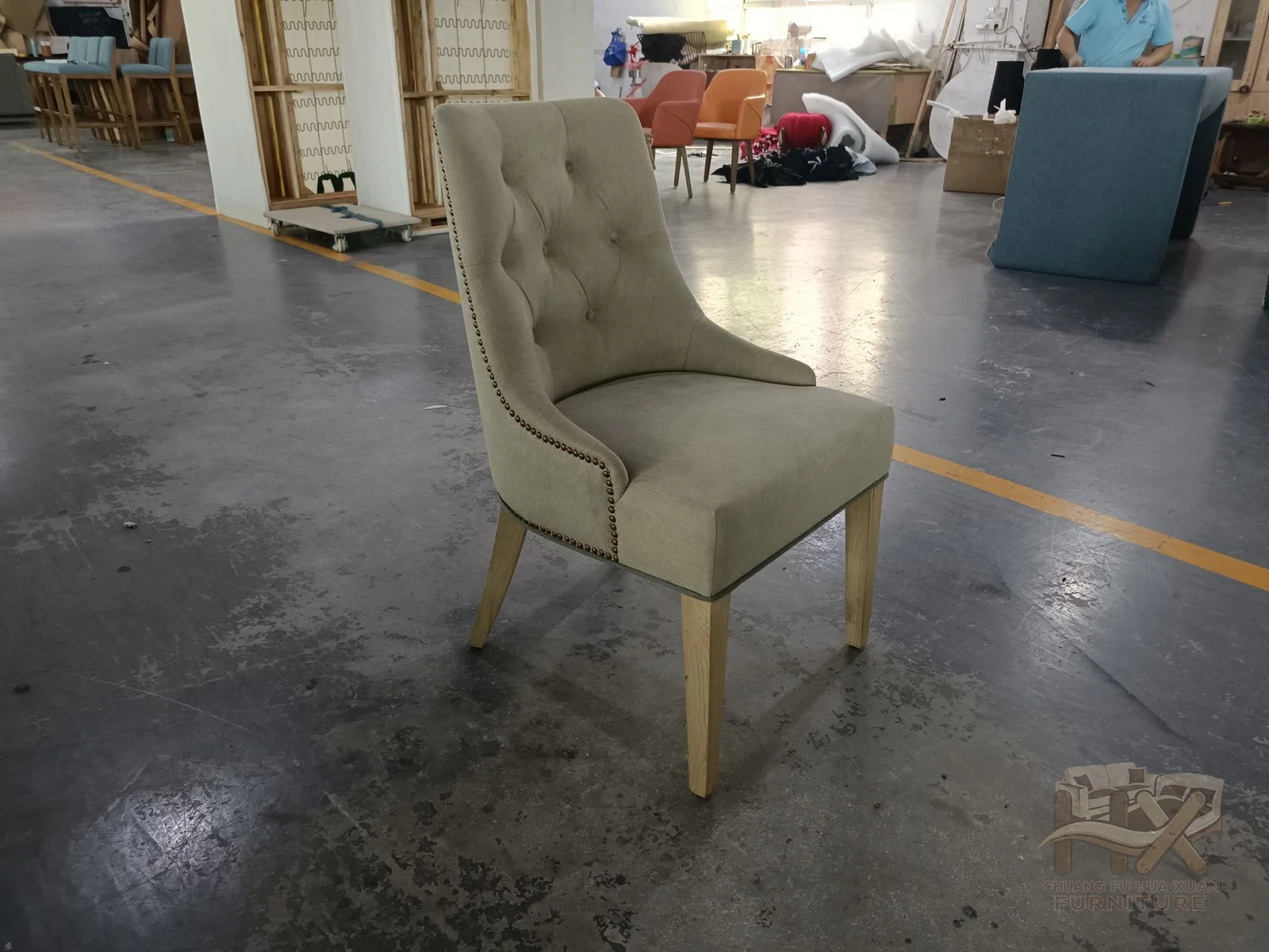 A pale dining chair rises into a tall shaped back over a slim padded seat.