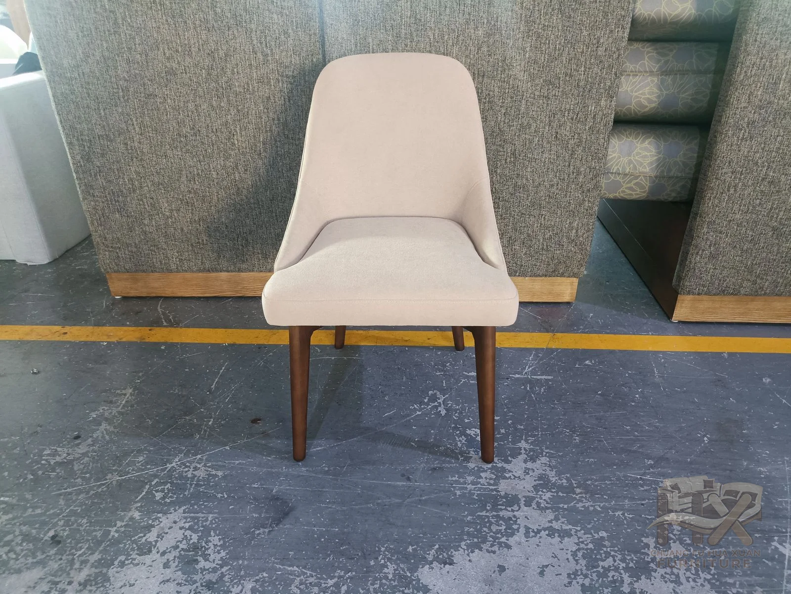 A cream dining chair curves its back into a compact seat above exposed wood-look legs.