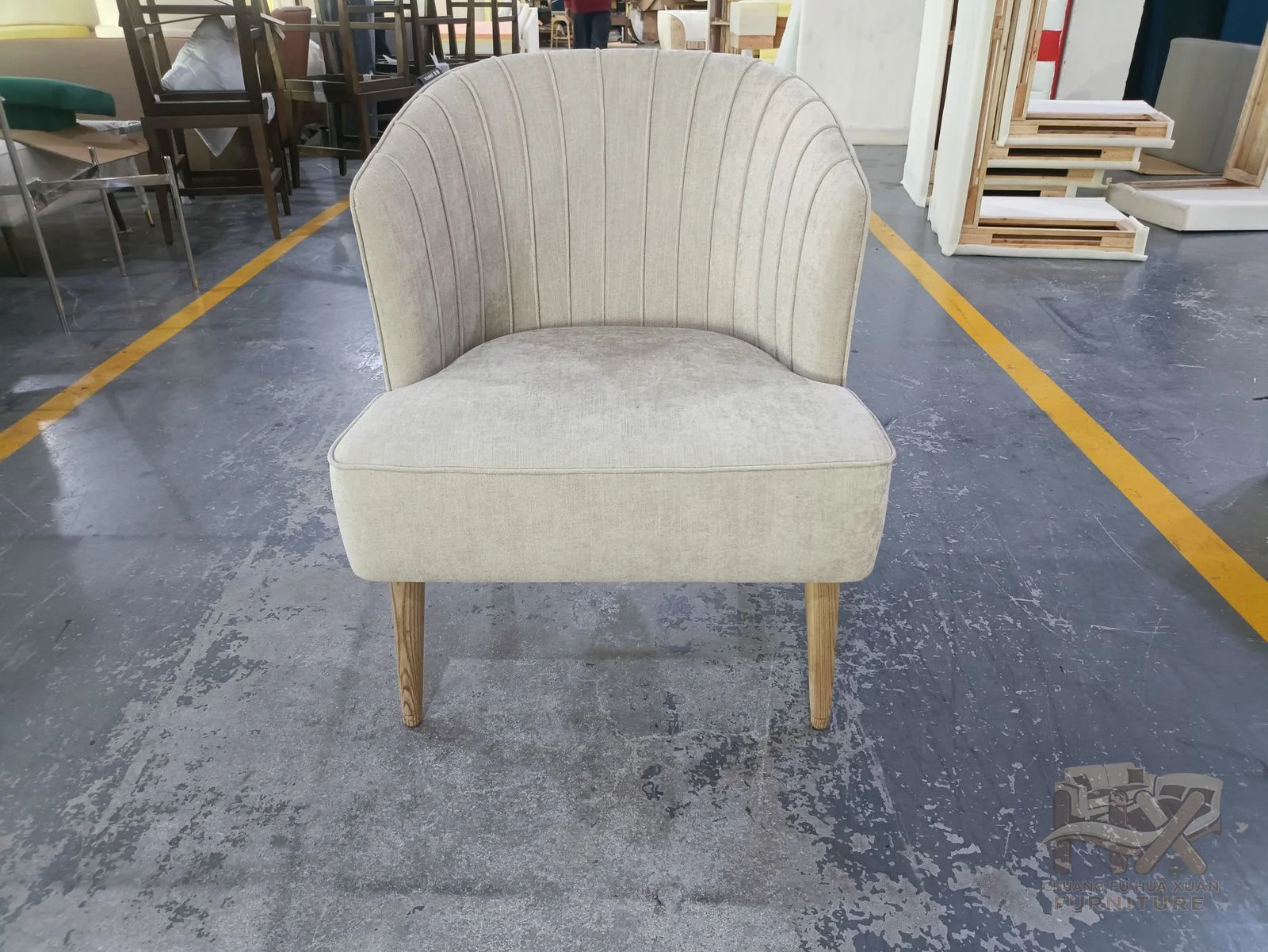 An ivory dining chair fans vertical seams across its curved high back above slim legs.