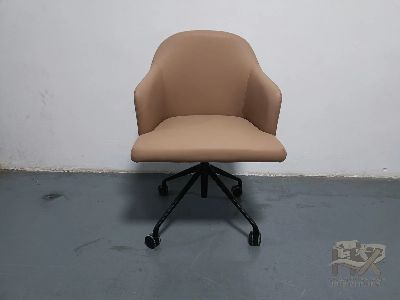 A tan padded dining shell rests on a slim dark swivel base.