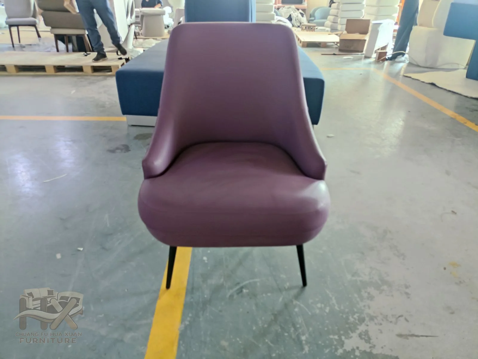 A plum upholstered dining chair has a tall shaped back on slim dark legs.