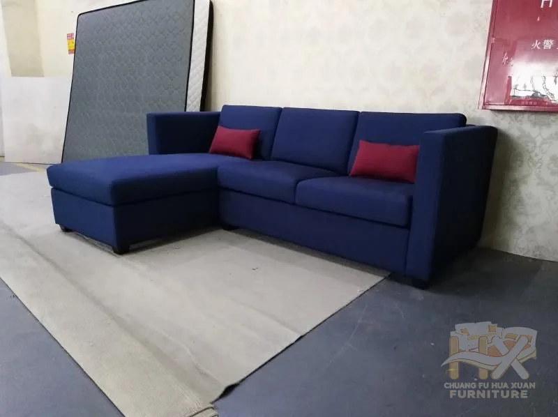 The navy L-shaped seat combines a chaise with a forward pull-out platform that levels the open surface.