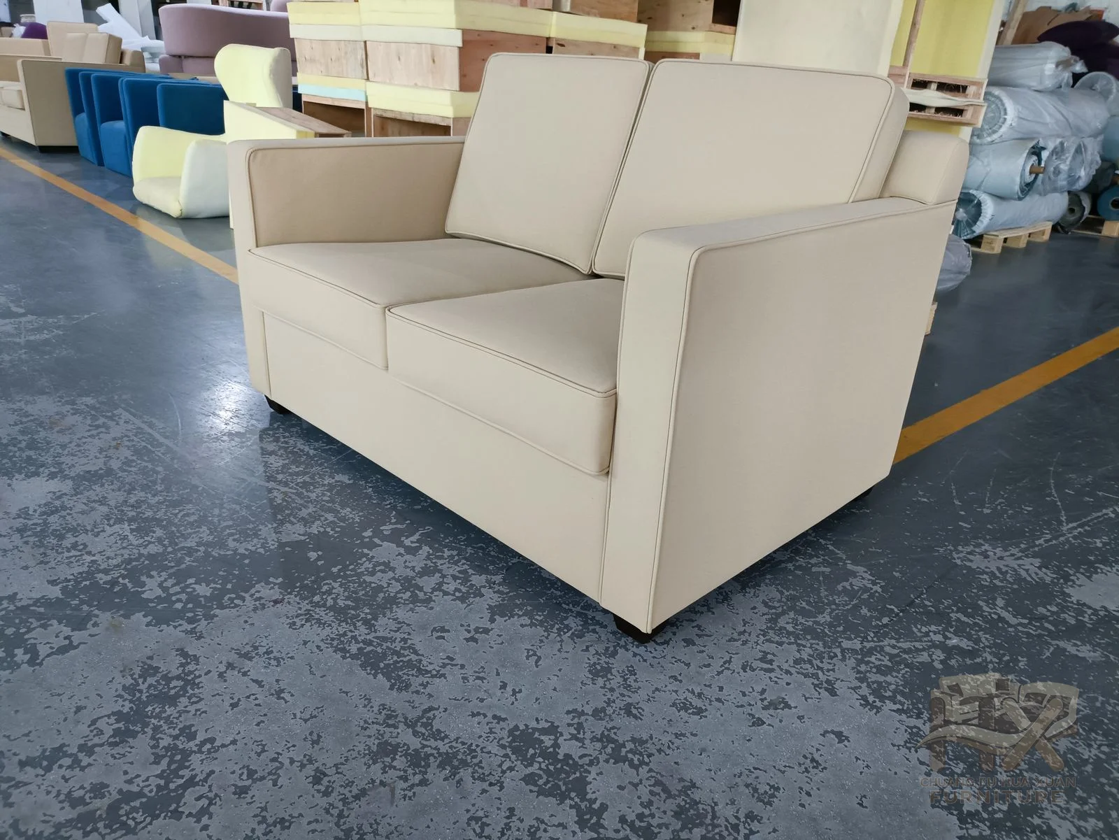 A box-arm ivory sofa opens forward to reveal a broad white sleeping surface while the back stays upright.