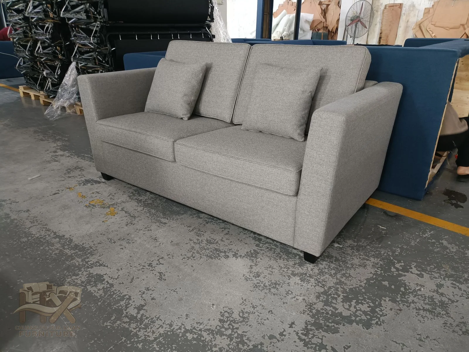 A pale straight sofa opens a broad white sleeping deck from below its cushioned seat.