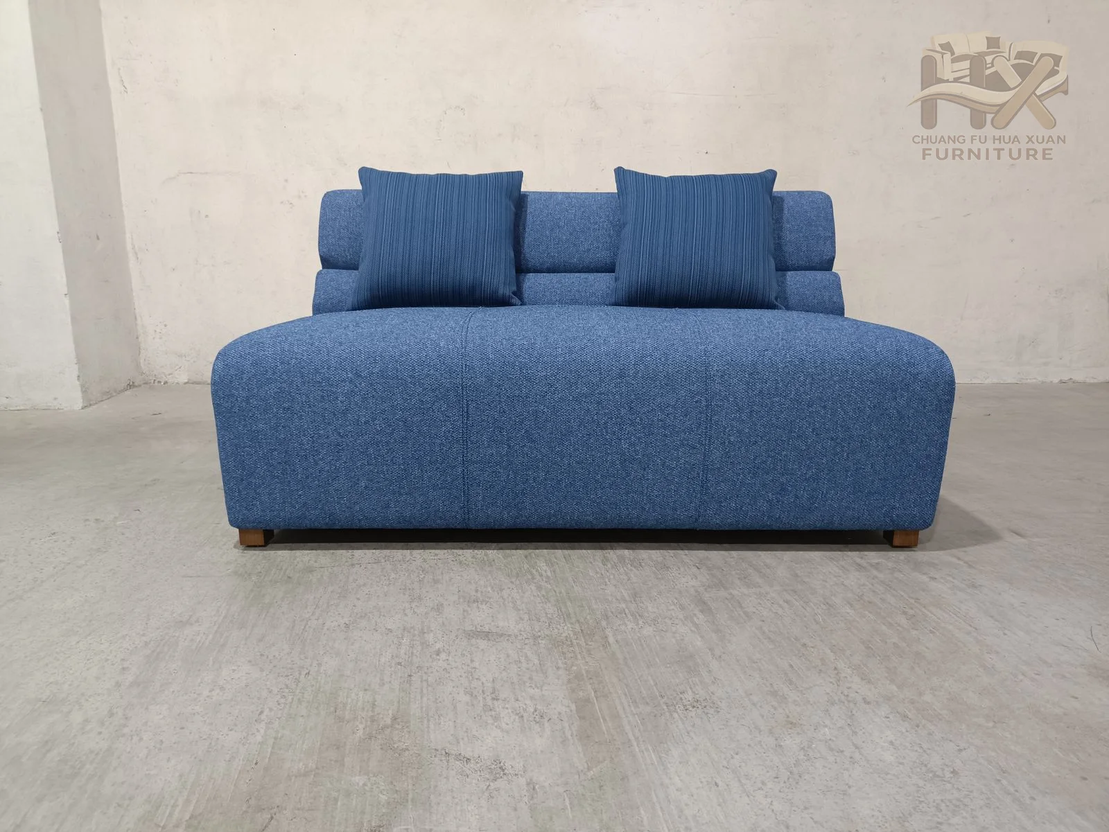 Low armless seats pair broad upholstered bases with raised back cushions; the images show both a plain back and a pillow-led arrangement.