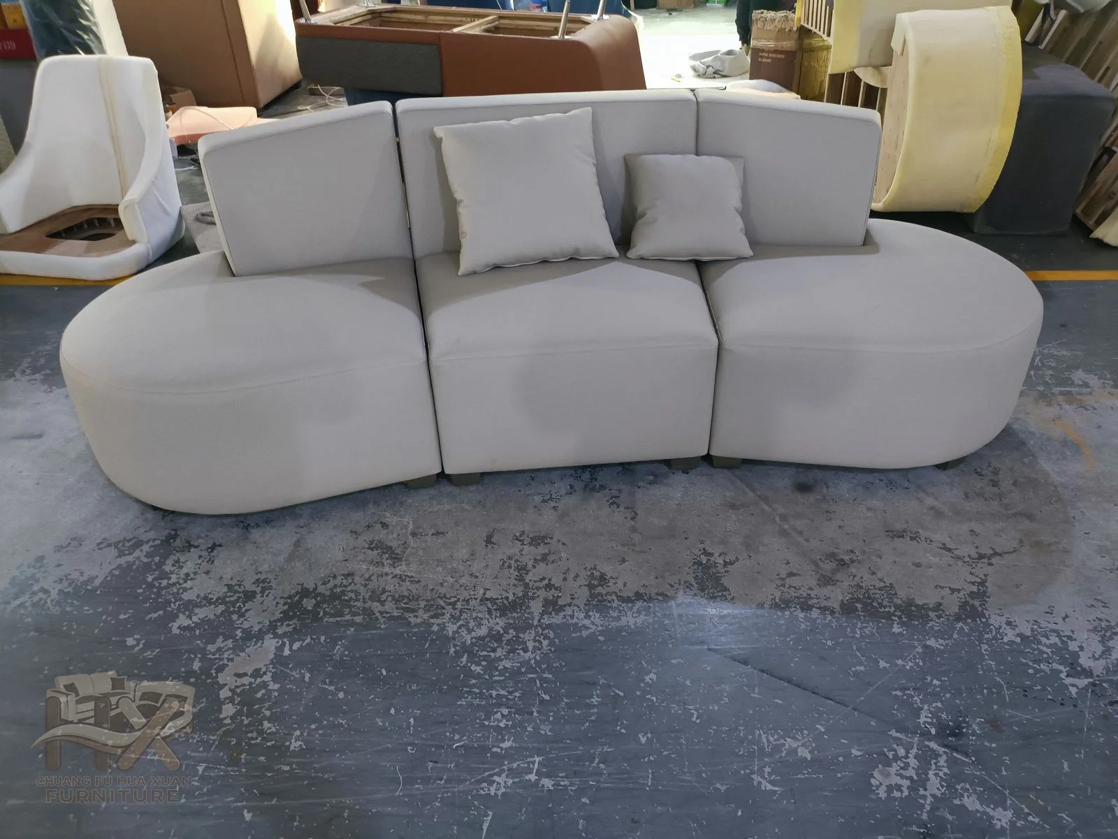 Oversized rounded modules make a soft, cloud-like white sofa with no exposed legs and a low back.