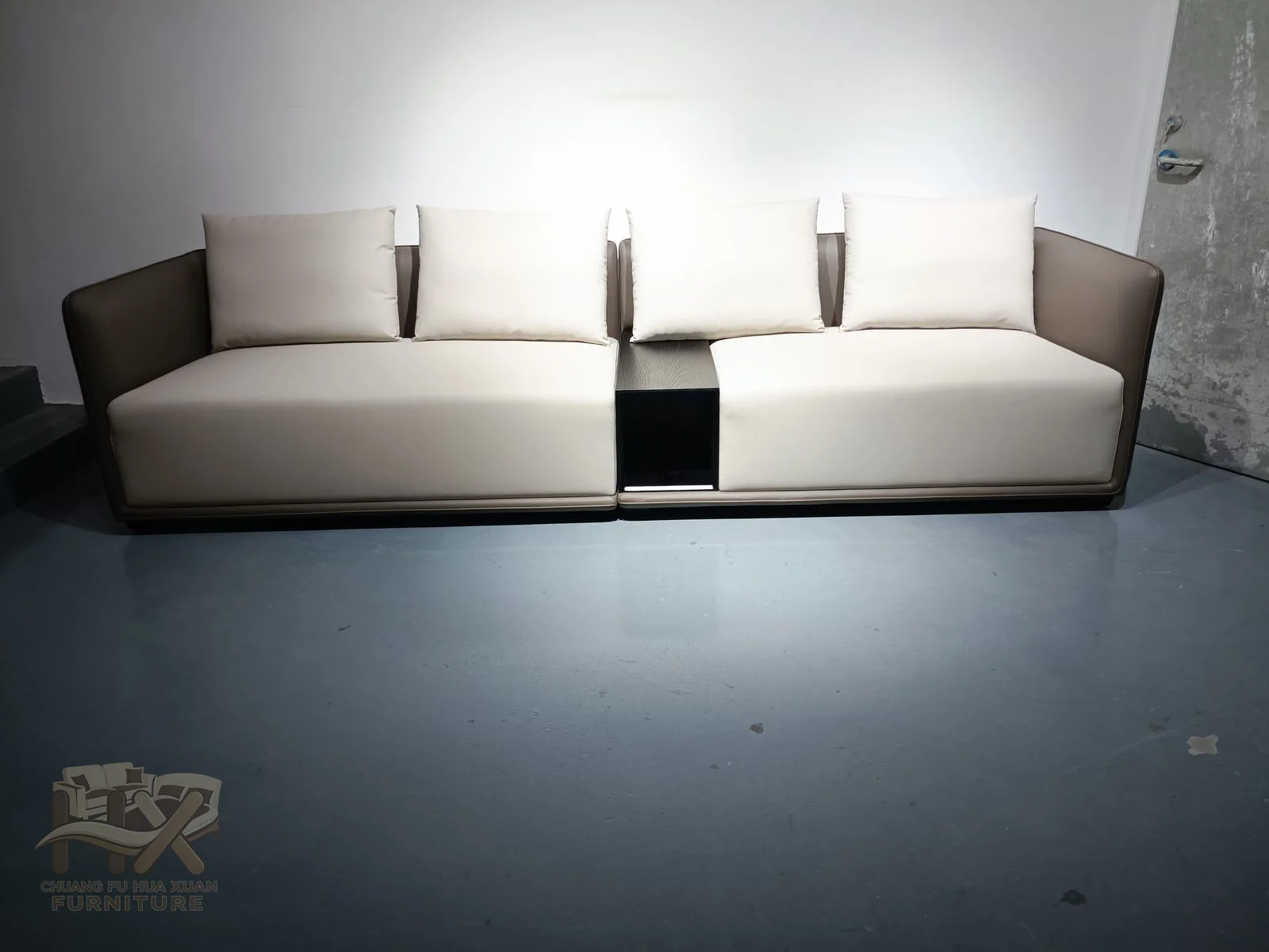 A long white sofa runs into a generous corner with repeated deep modules and low straight arms.