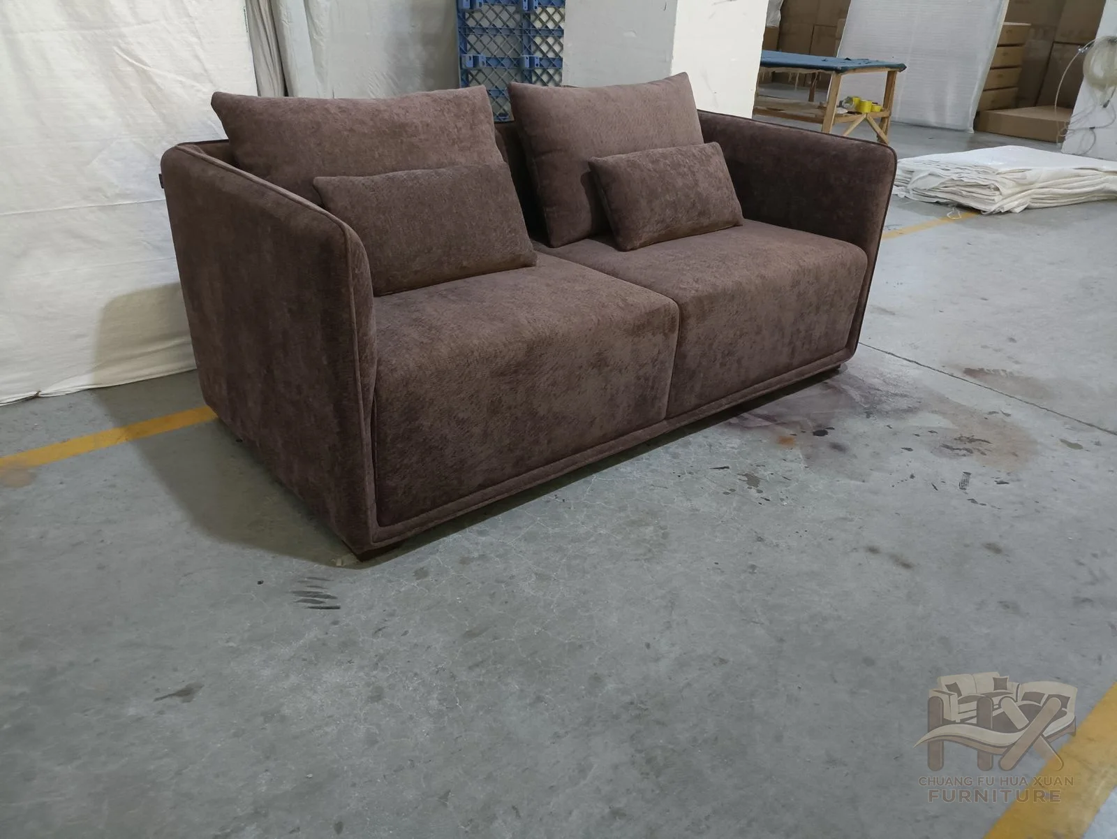Two deep dark-grey seats sit below thick loose back cushions within short rounded arms.
