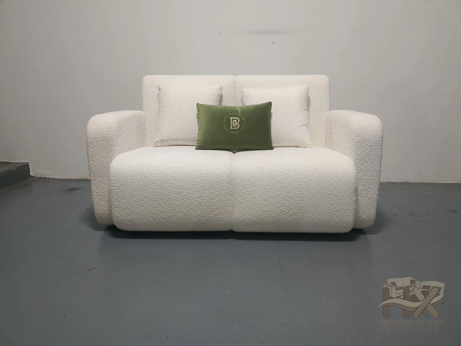 Rounded white arms turn inward around two seat positions and a low cushioned back.
