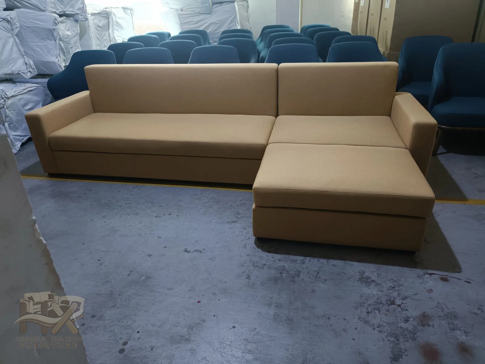 A broad taupe corner sectional extends a long cushion run around a low right-angle return.